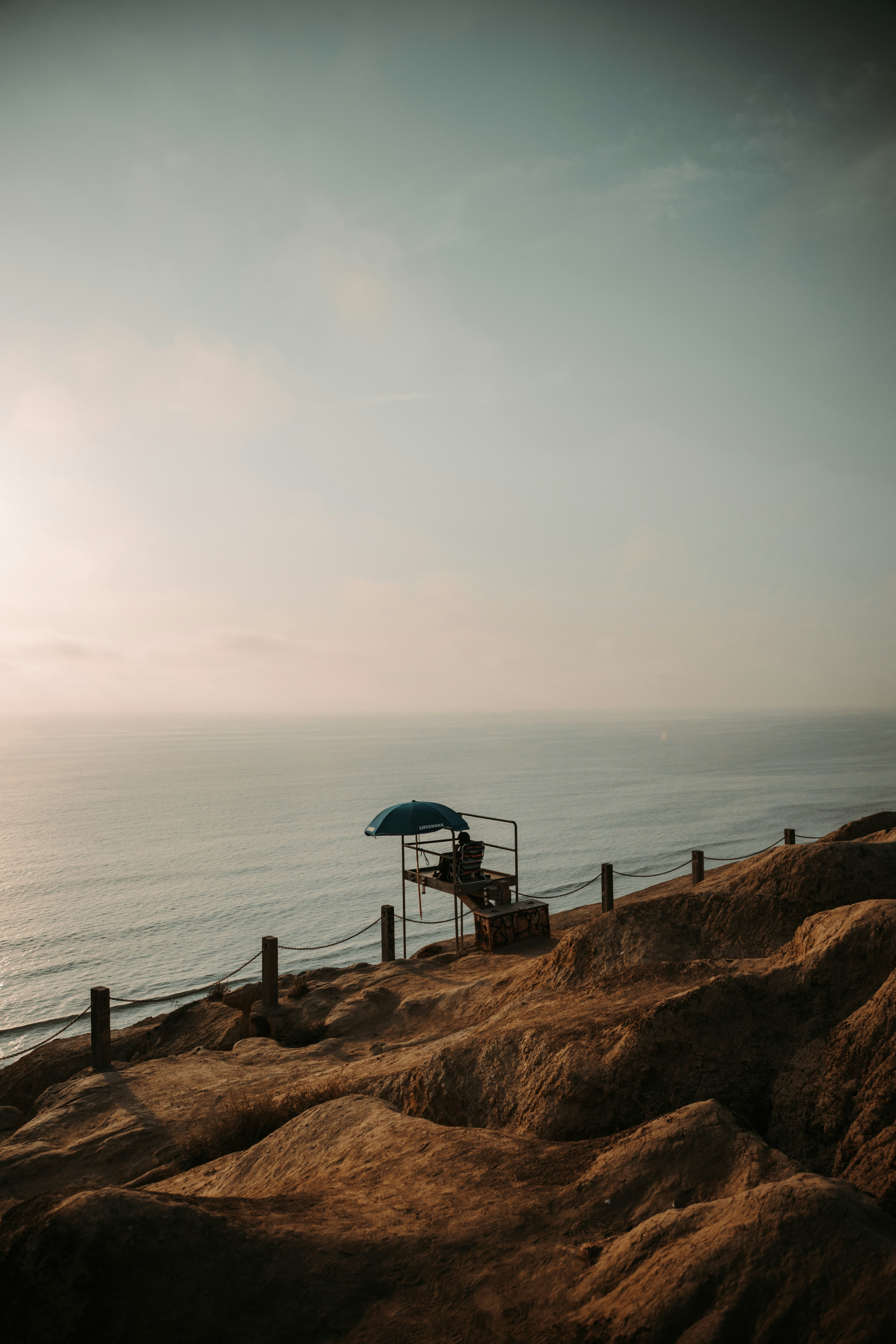 Lifeguard tower on a cliff overlooking the ocean.