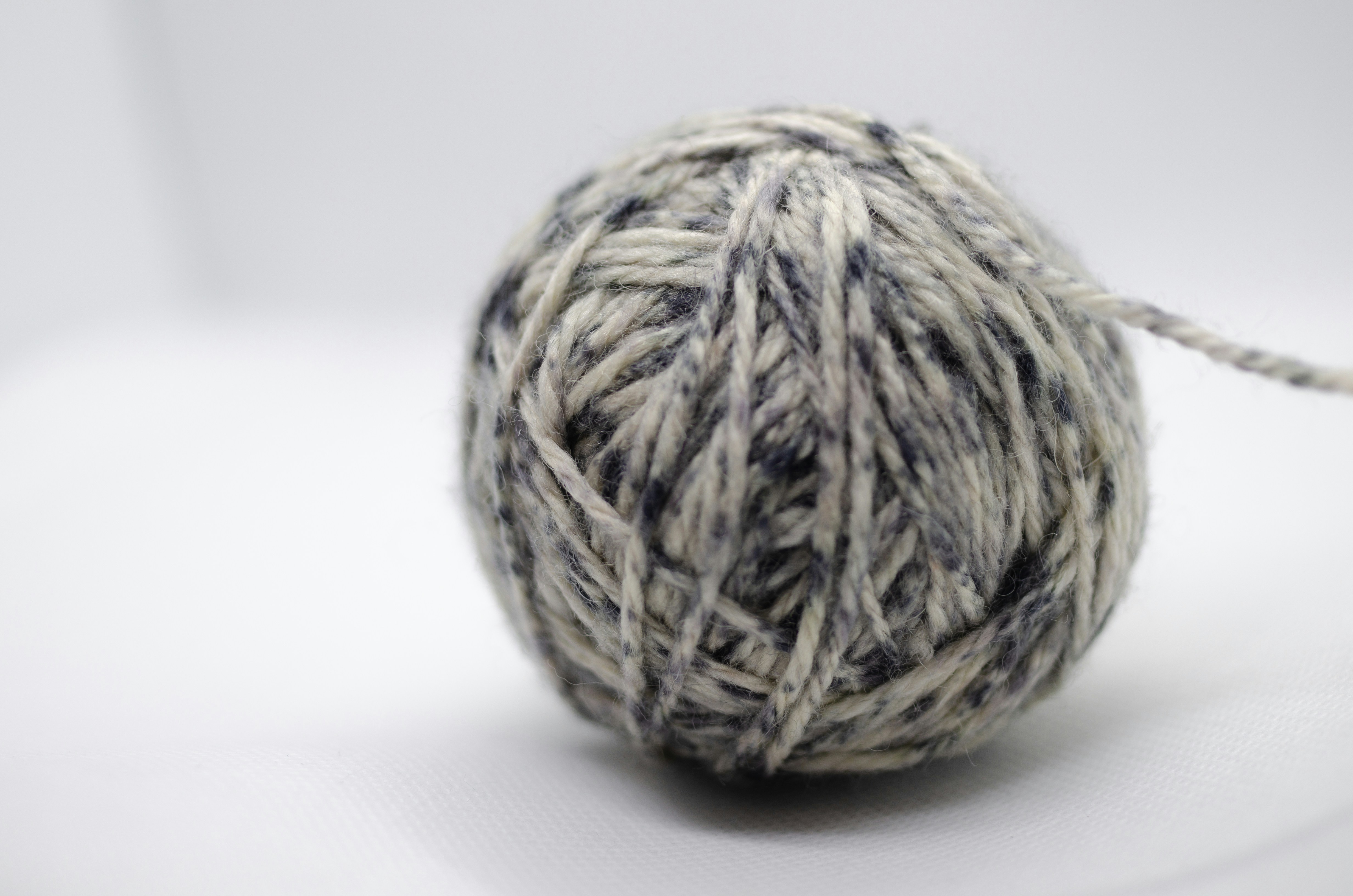 A ball of grey and white yarn