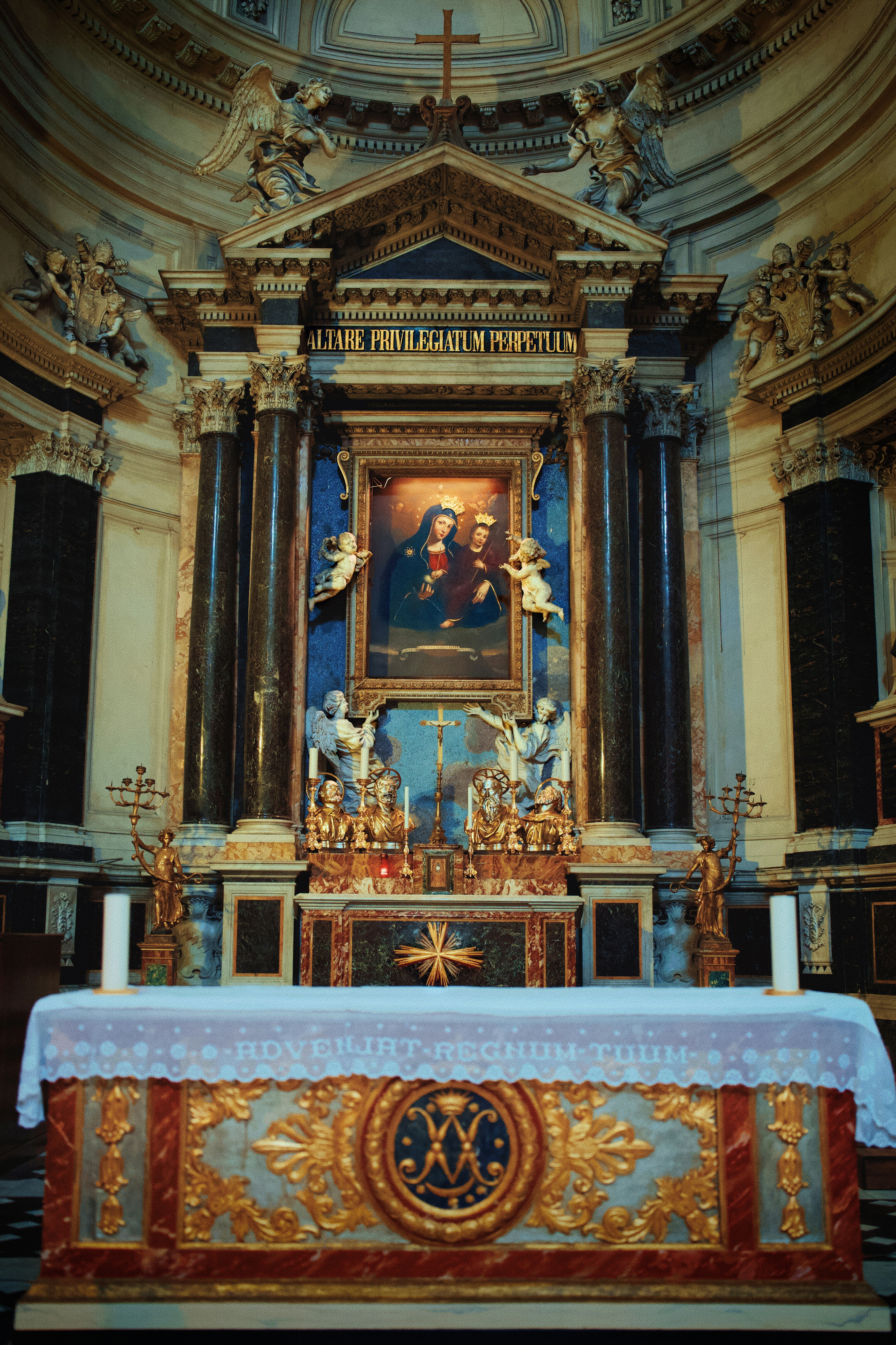 Ornate altar with religious painting in a grand church.