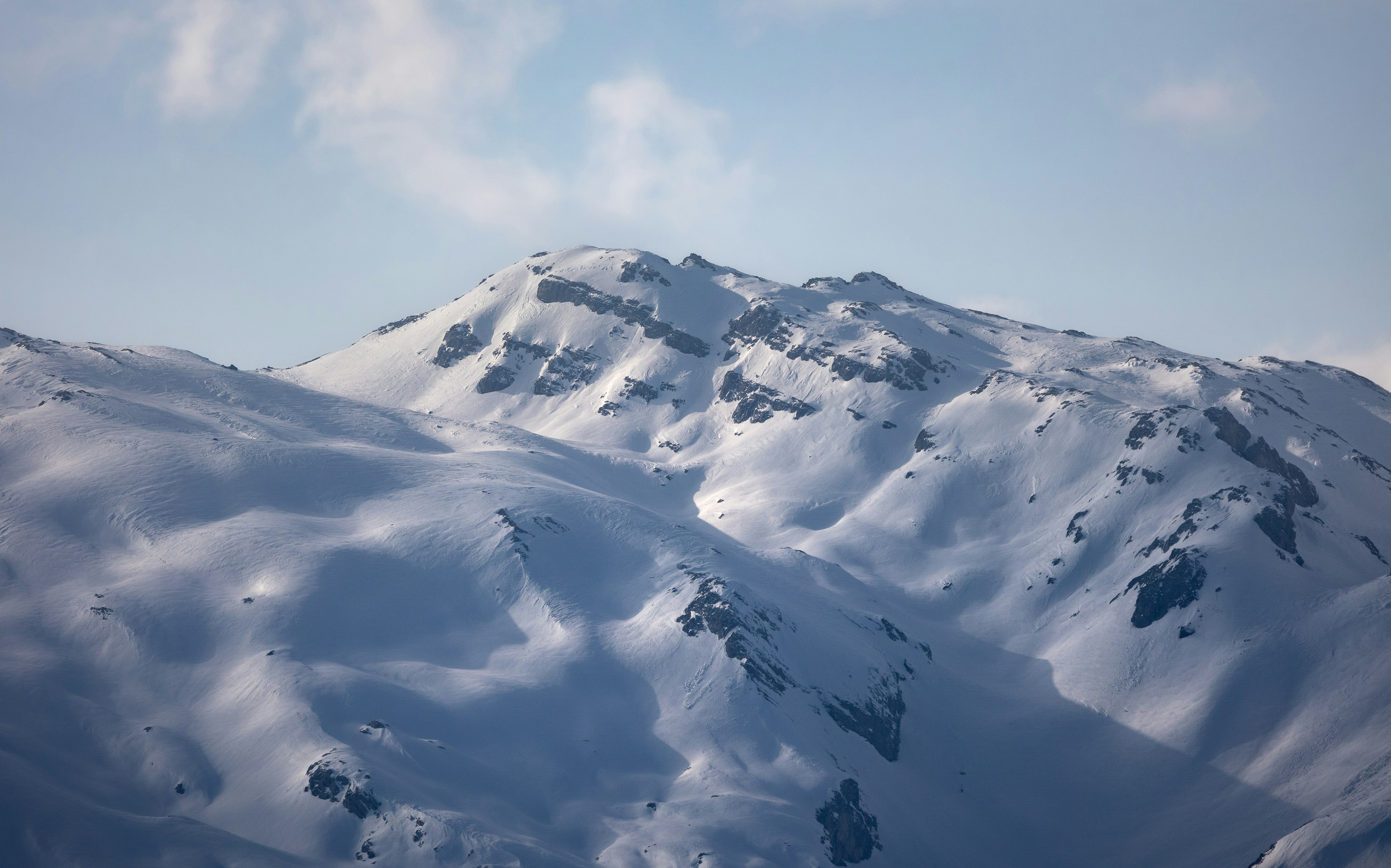 Snow-covered mountain peaks under a clear sky
