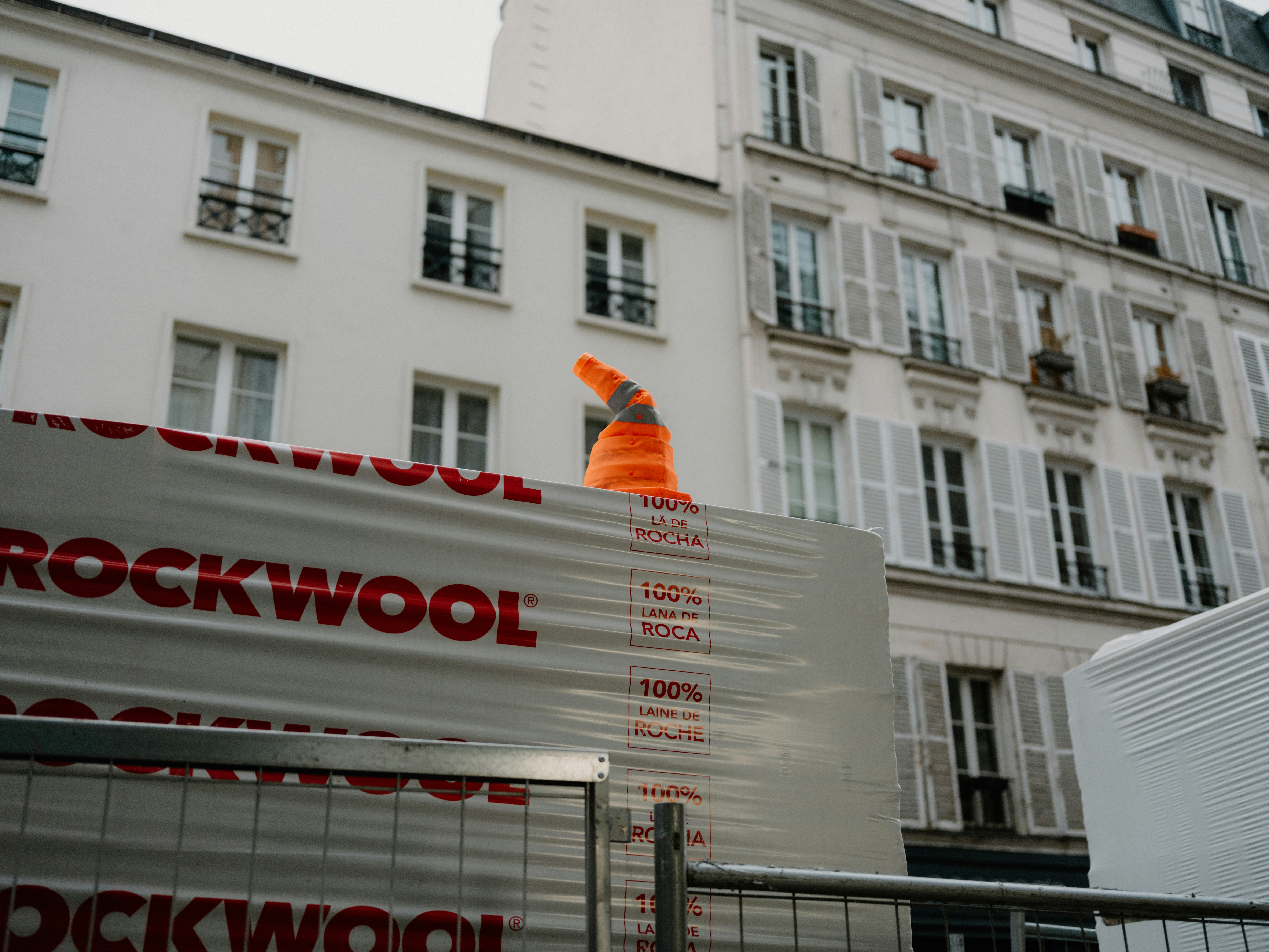 Orange traffic cone on construction materials