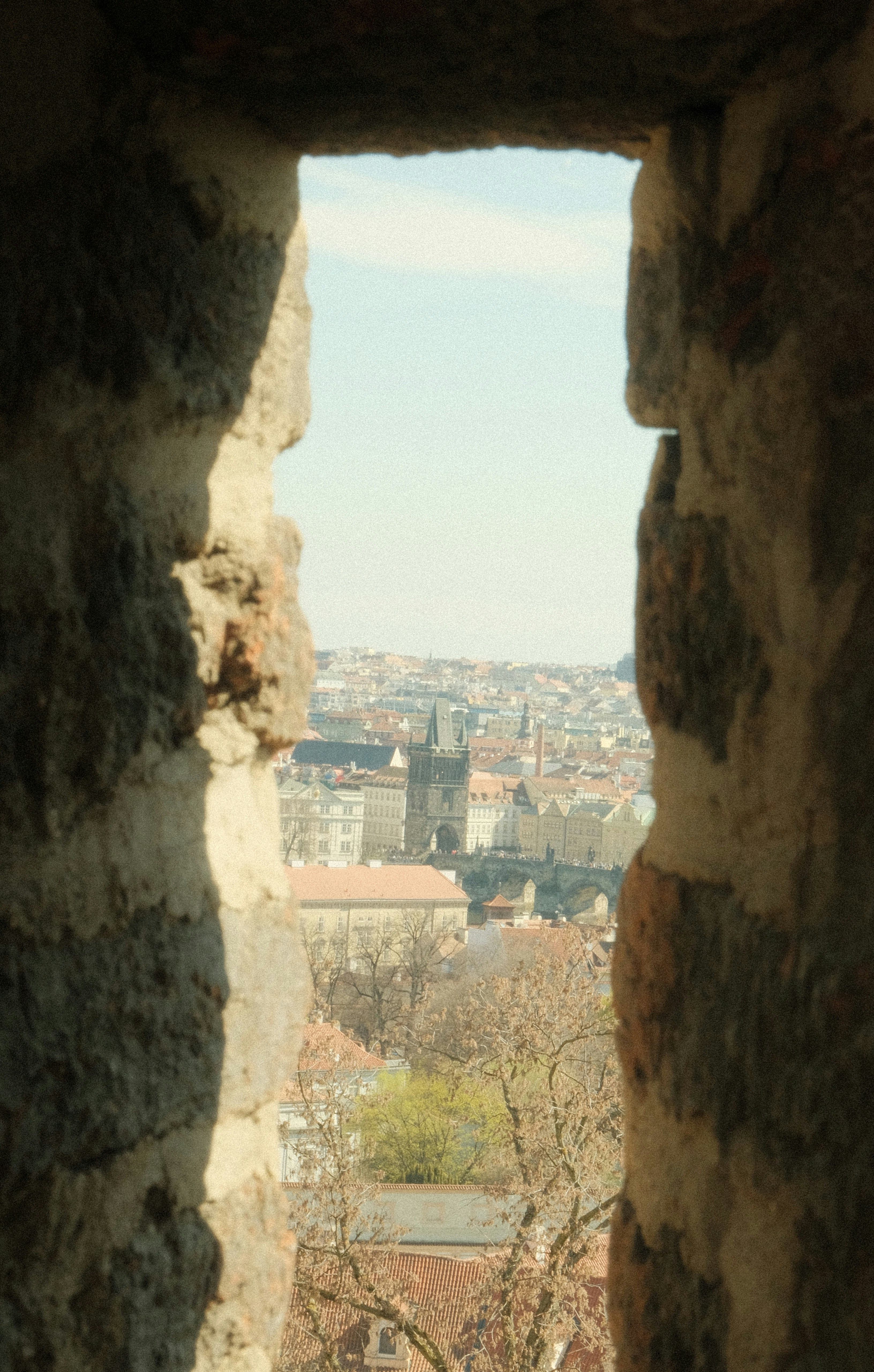 View of a city through a stone window opening