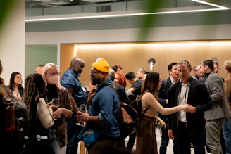 People mingling at an indoor event with warm lighting