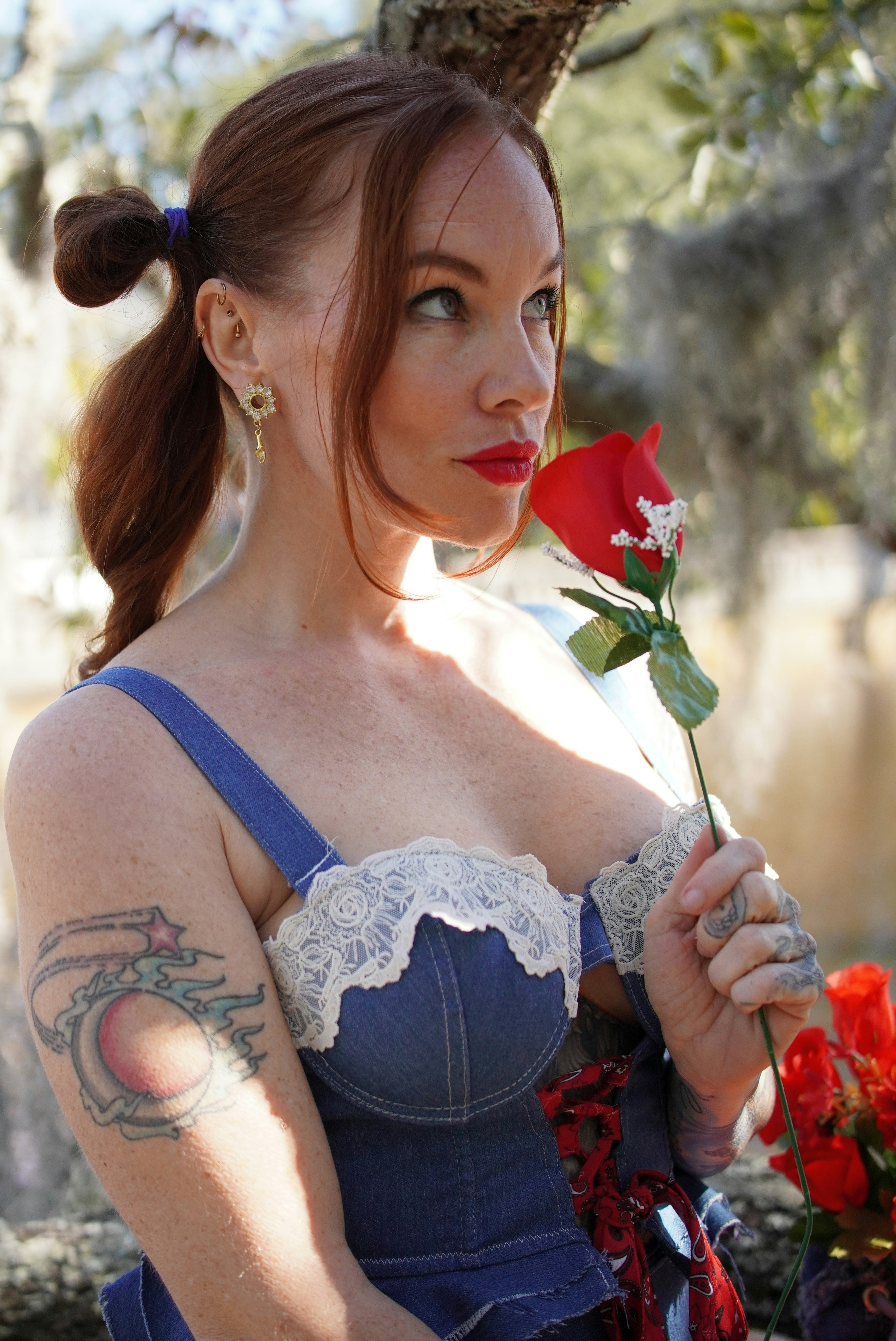 Woman with red rose and denim outfit
