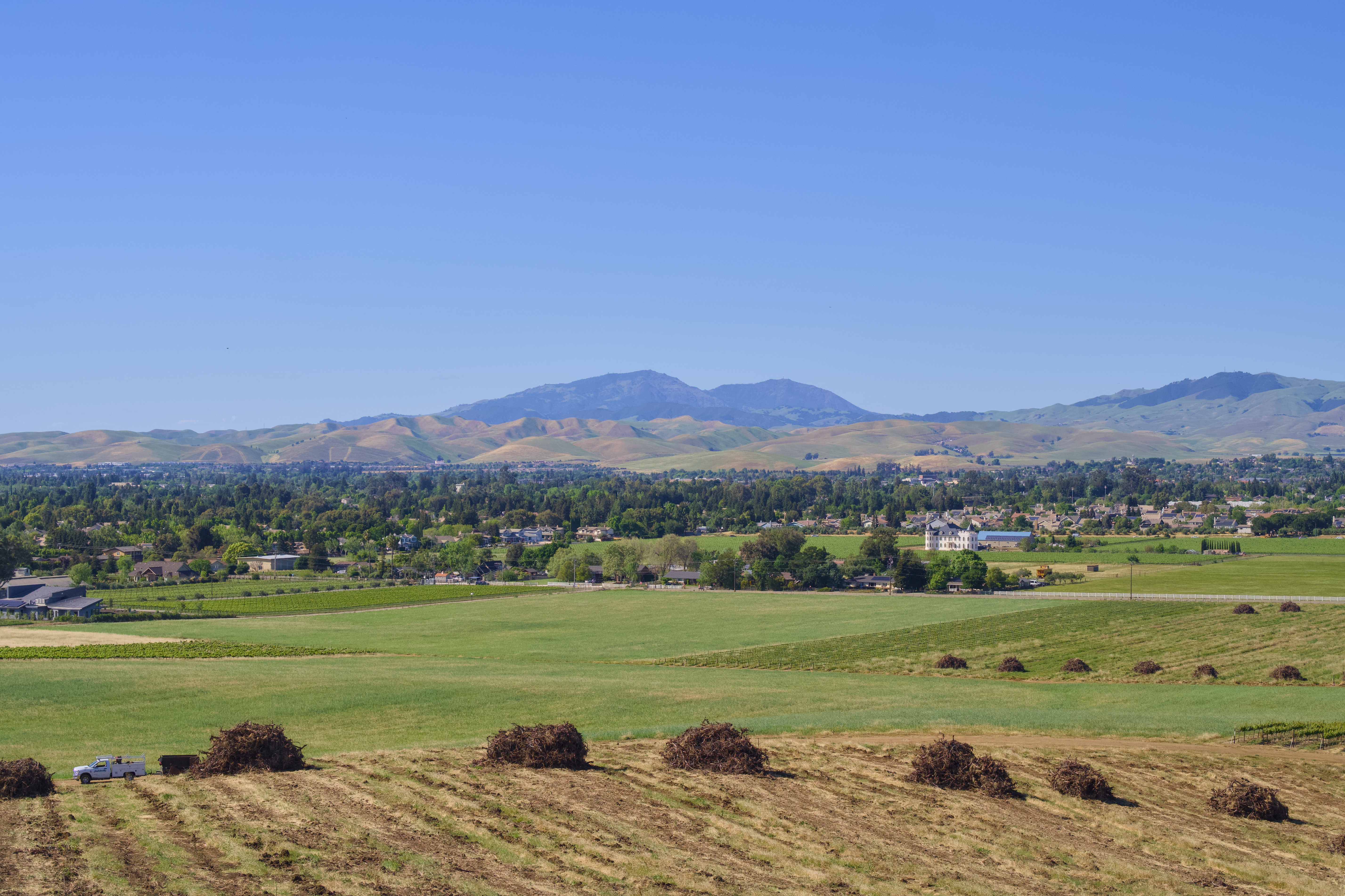 Rural landscape with rolling hills and distant mountains