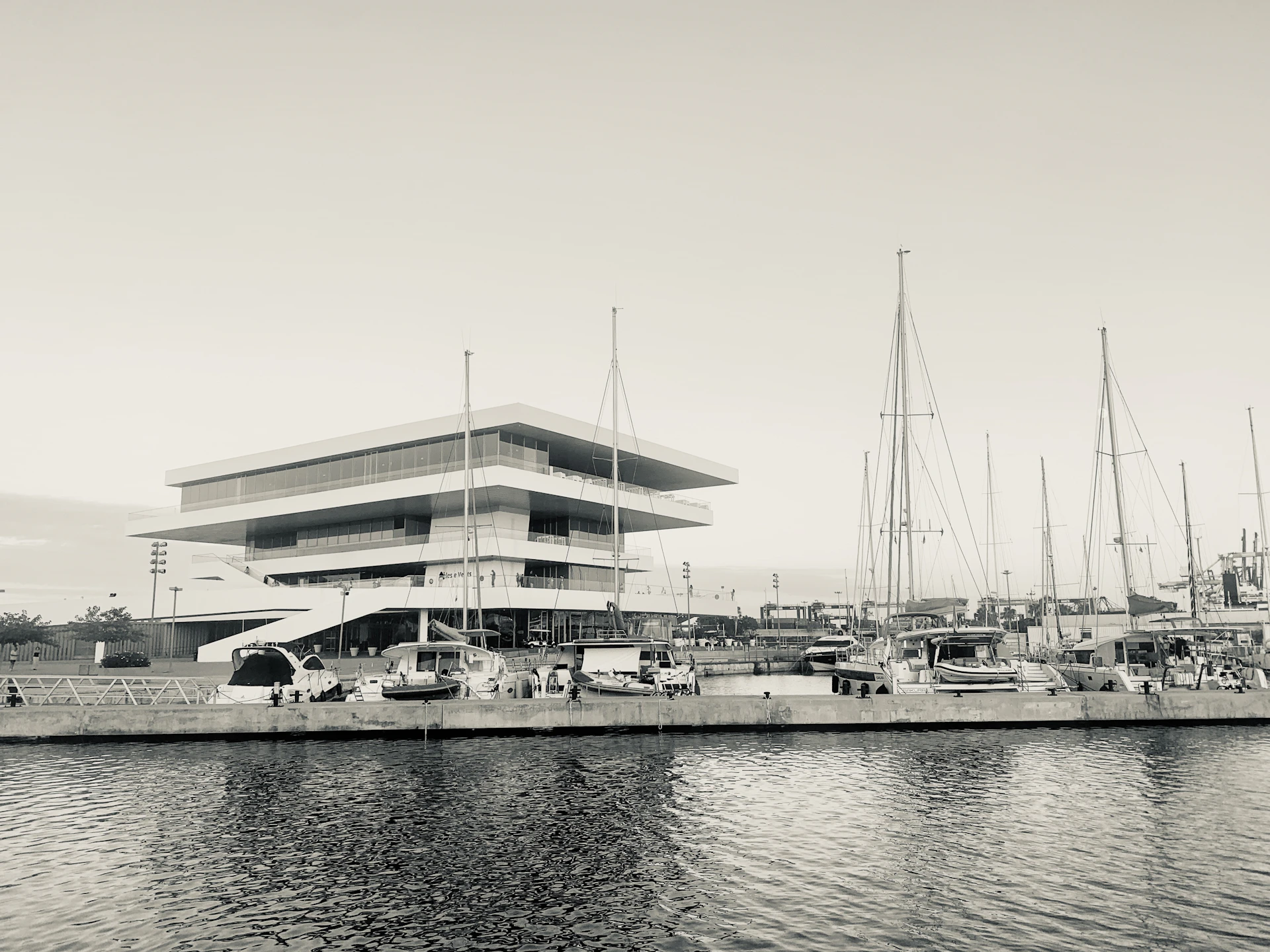 Modern building with sailboats docked at marina