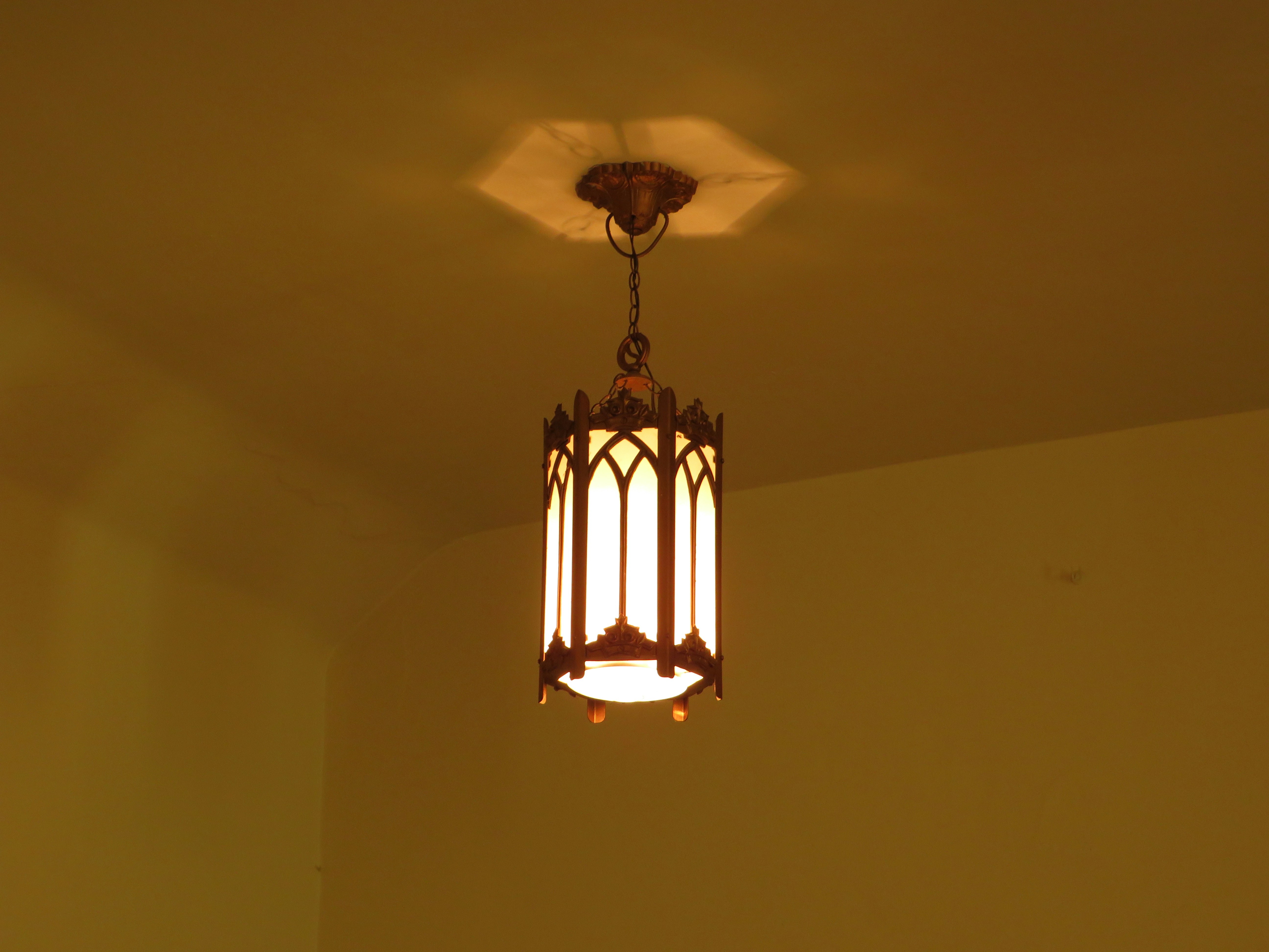 Ornate ceiling light fixture with glass panels.