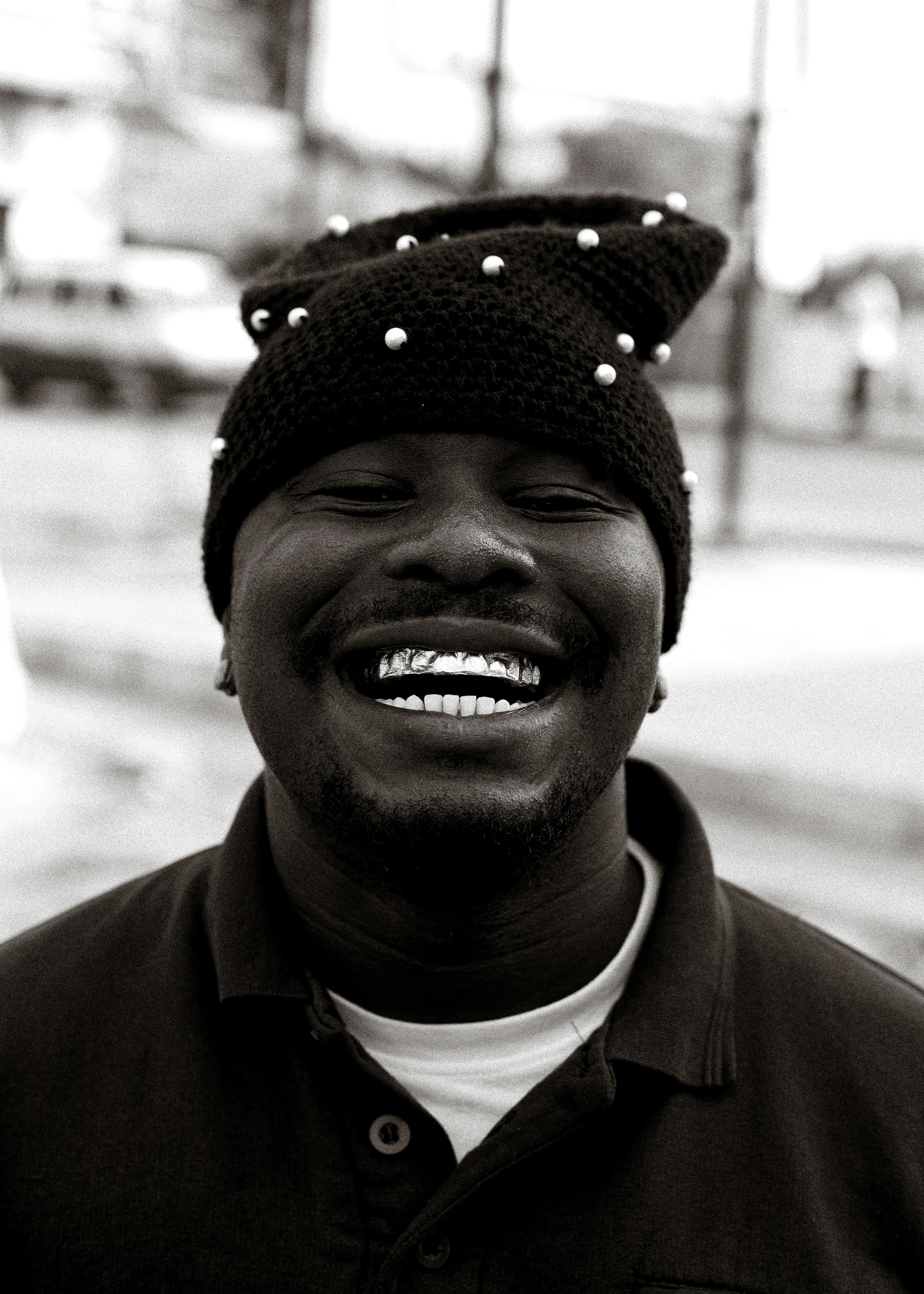Man wearing a beaded beanie and smiling