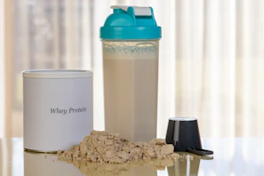 Whey protein powder with shaker bottle and scoop
