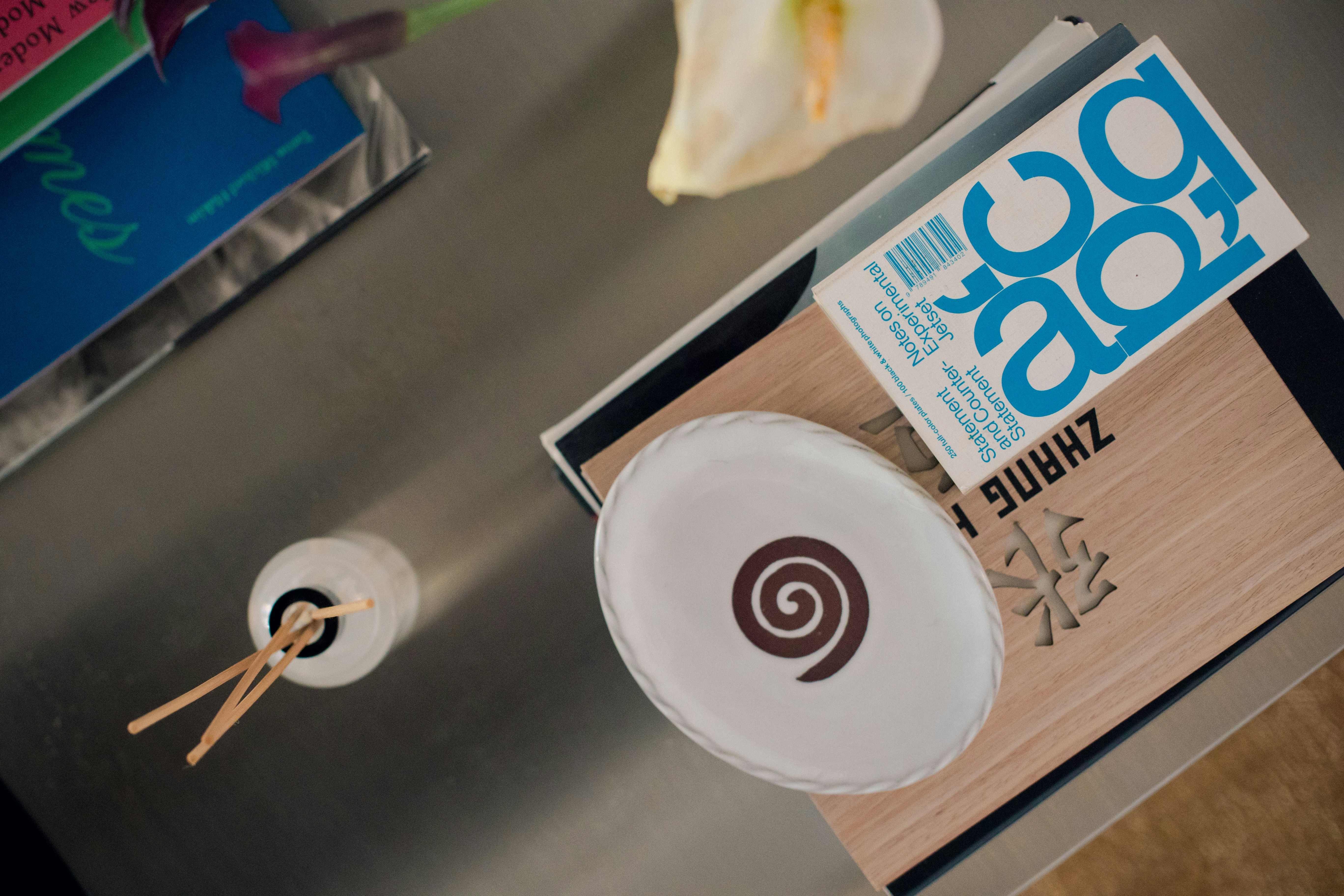 Piring oval putih dengan spiral coklat pada buku.