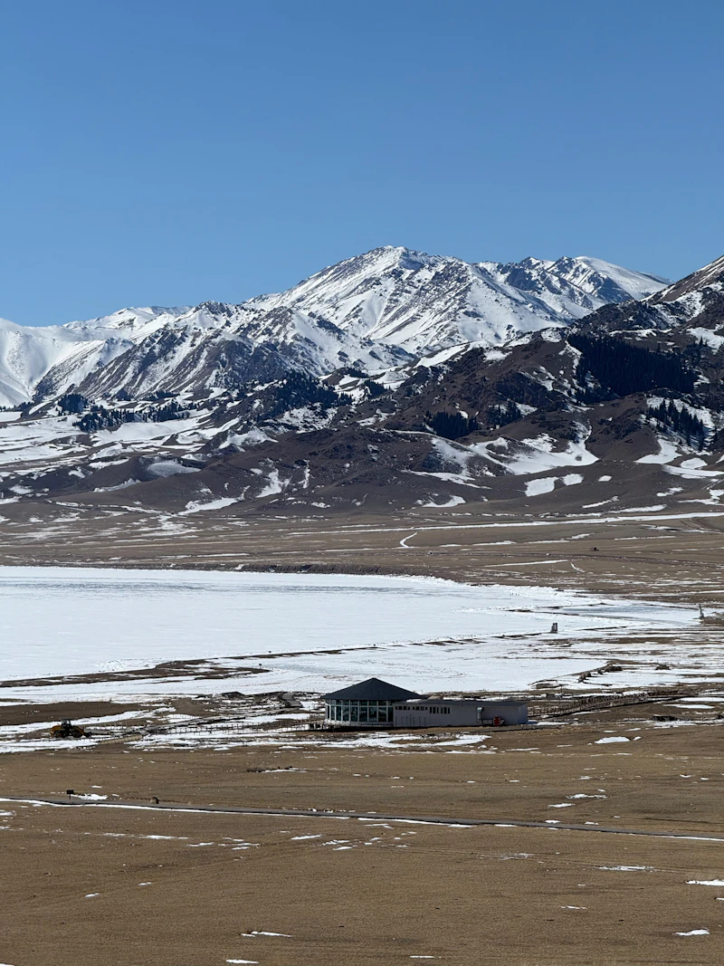 Snowy mountains overlooking a frozen lake