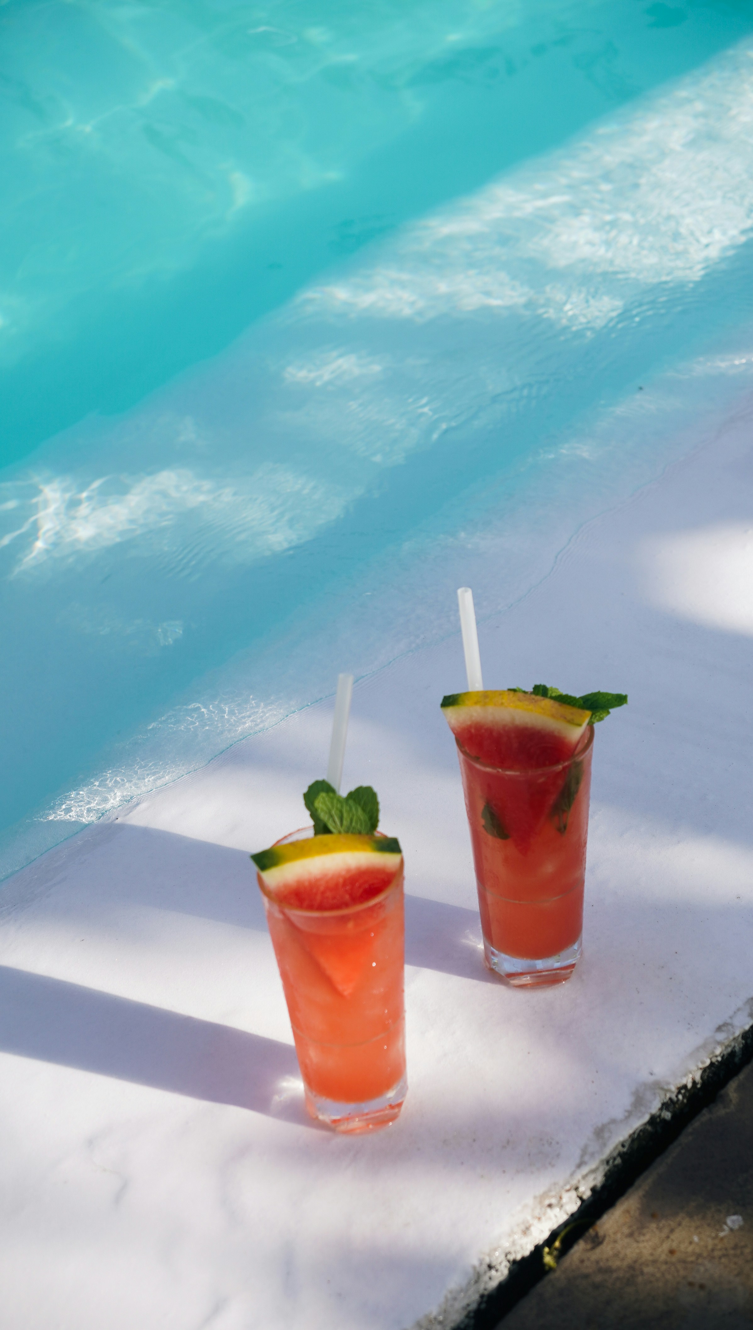 Two refreshing cocktails by the pool