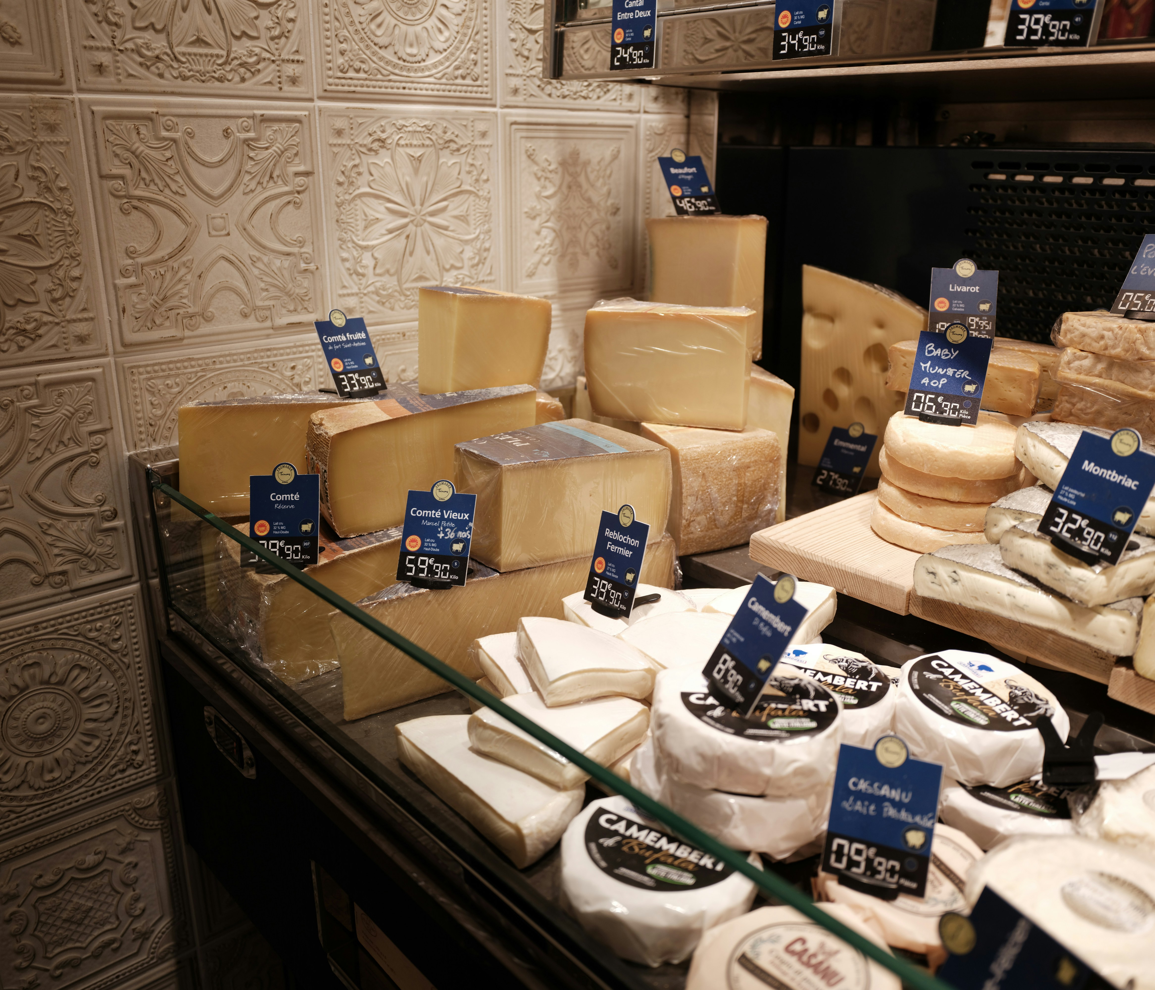 Assortment of cheeses displayed in a shop.