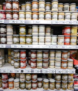 Jars of preserves and condiments displayed on supermarket shelves.