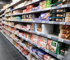 Shelves stocked with various cookies and biscuits in a store.