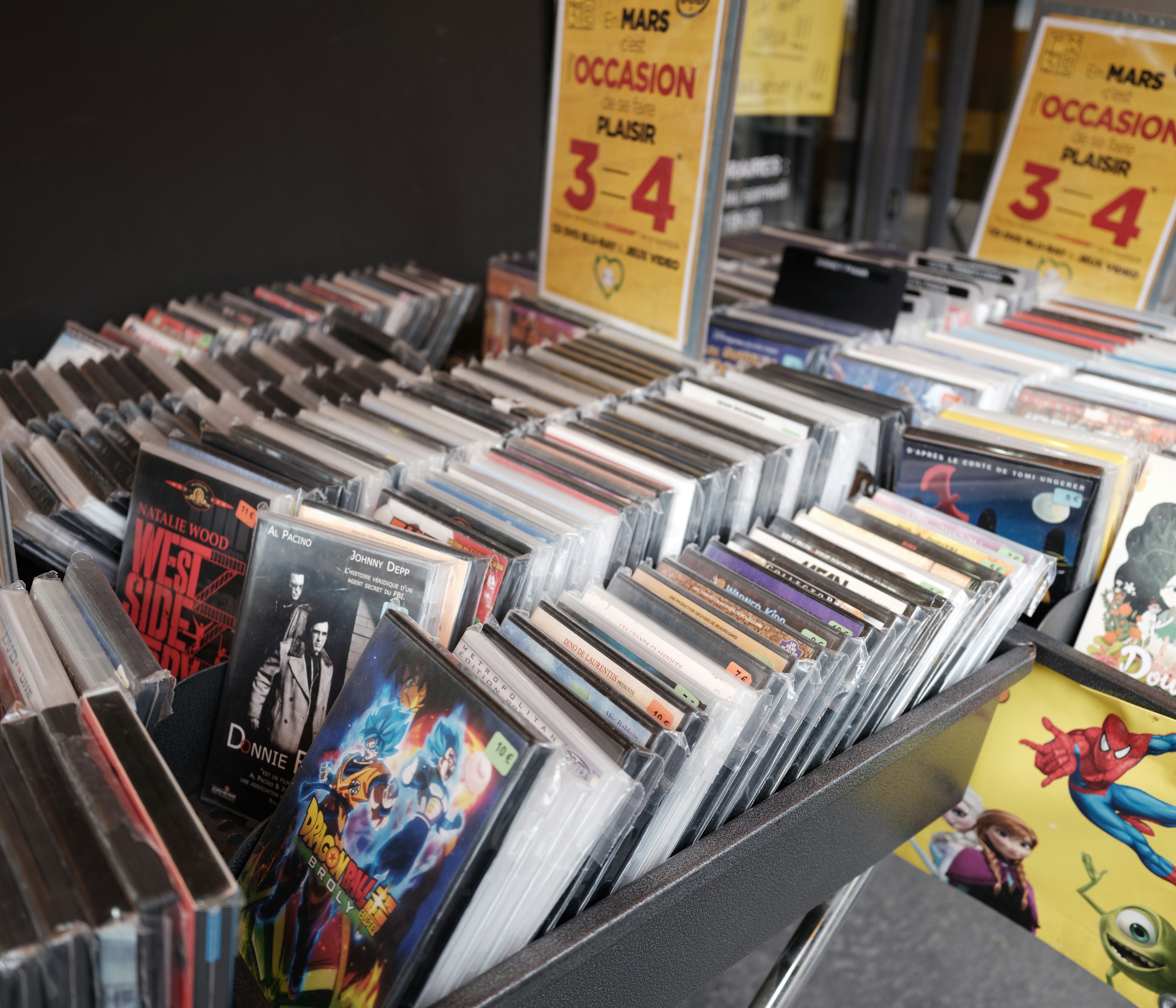 Rows of cds and dvds displayed in a store.