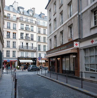 A narrow street in paris with traditional buildings.