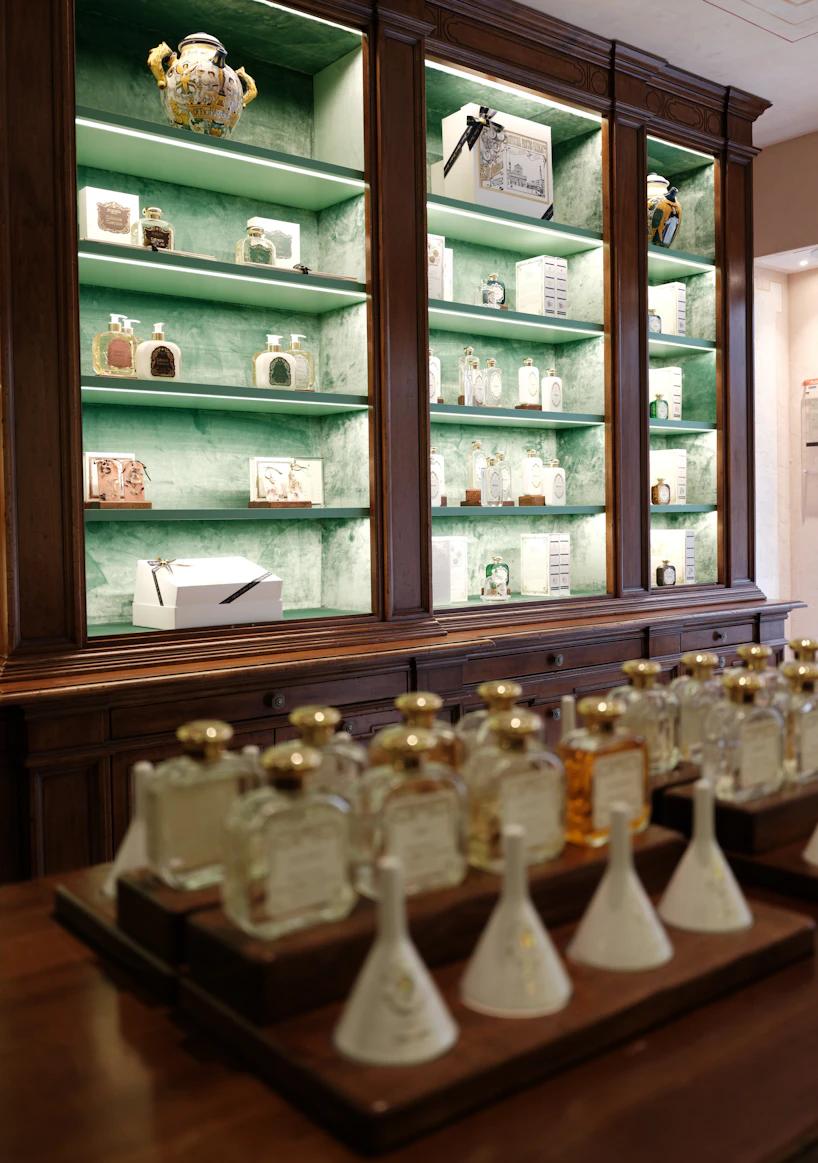 A French apothecary — glass vials, marble counters, calligraphed labels