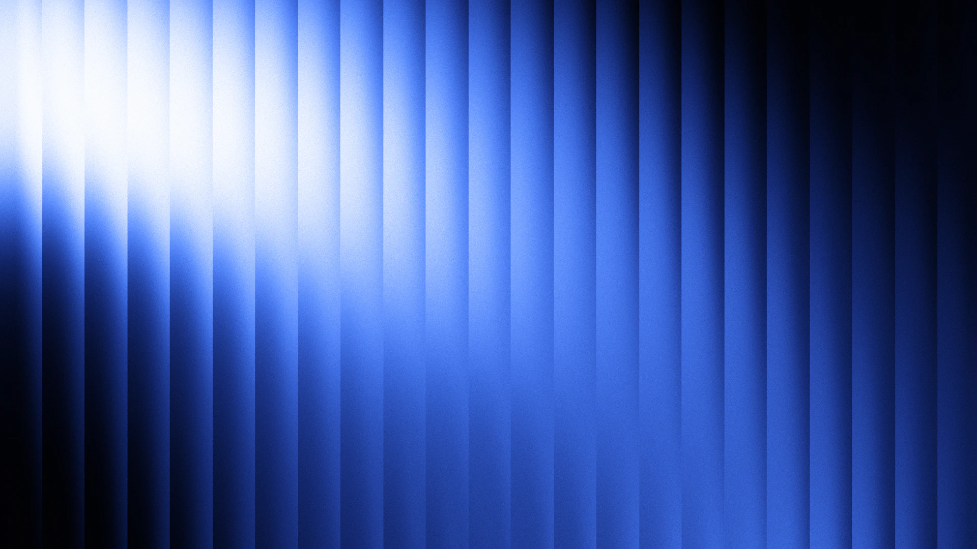 A bright light shines on a blue striped background