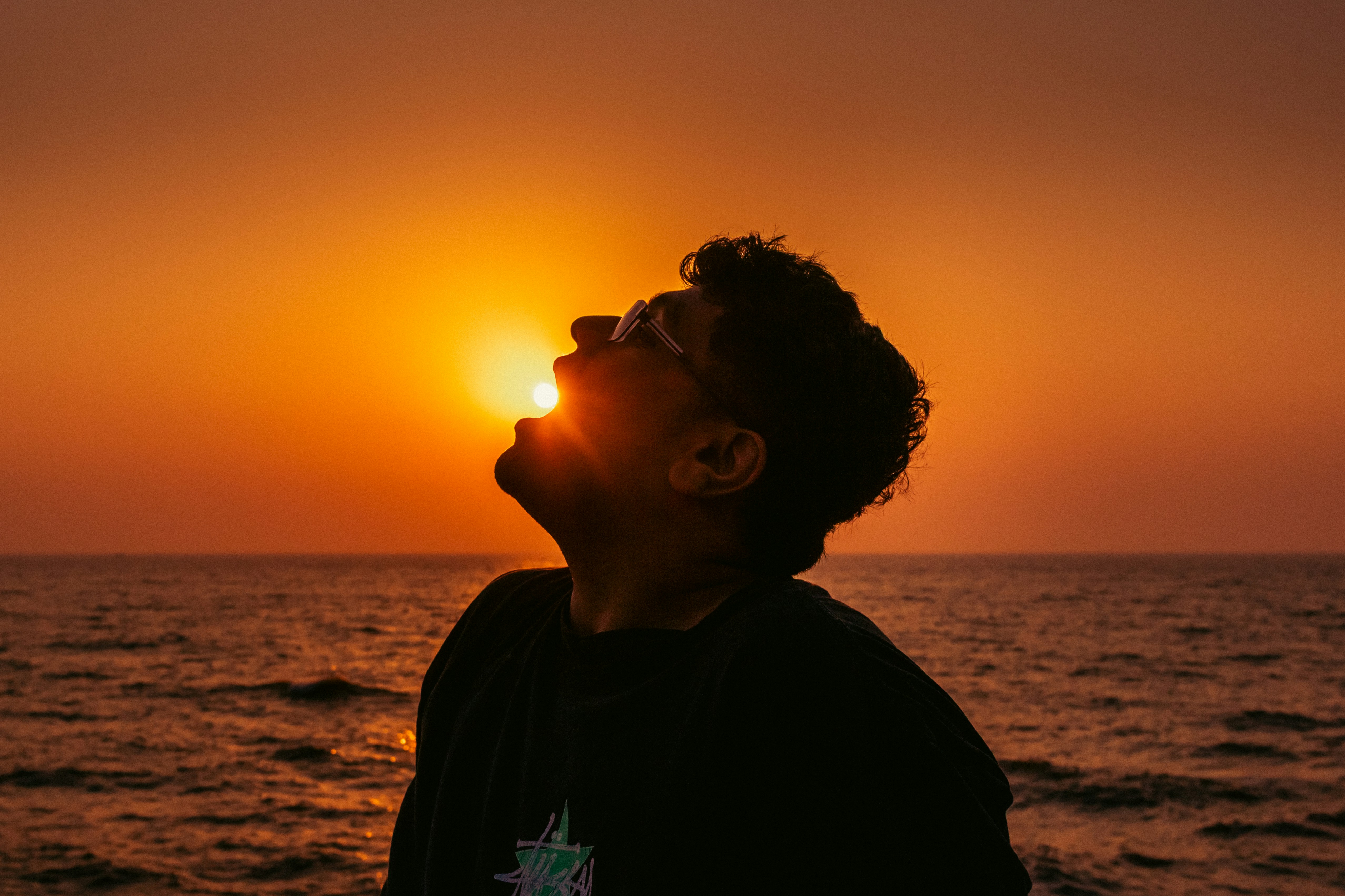 Man looking up at the sun at sunset