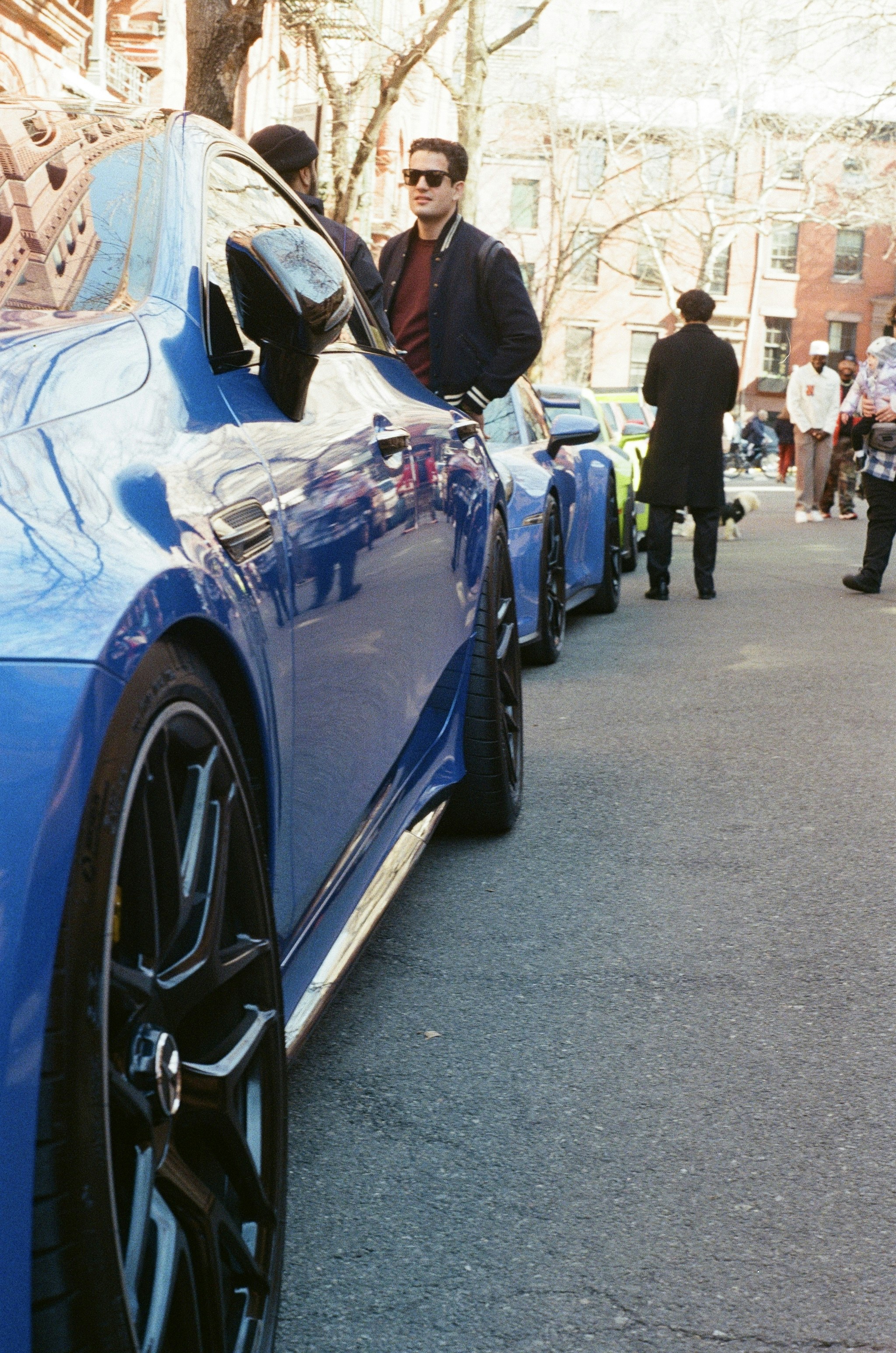Blue sports cars parked on a city street.