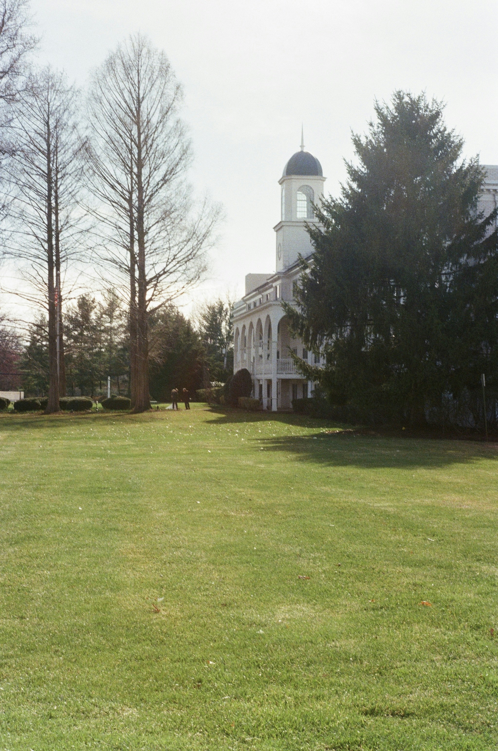 White building with a steeple and green lawn, representing the campus feel of a faith-based school like Whitesburg Christian Academy