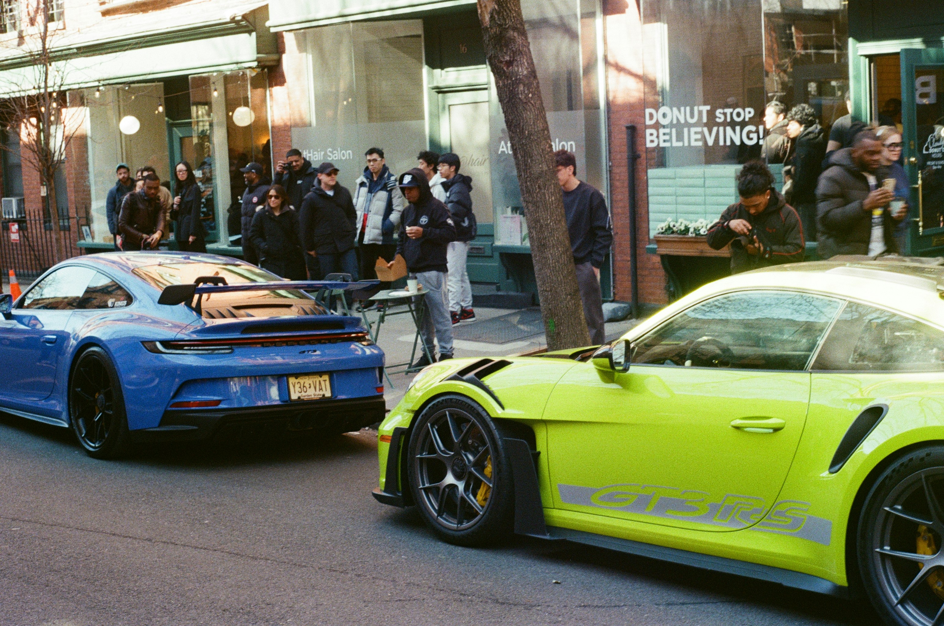 Two sports cars parked on a city street.