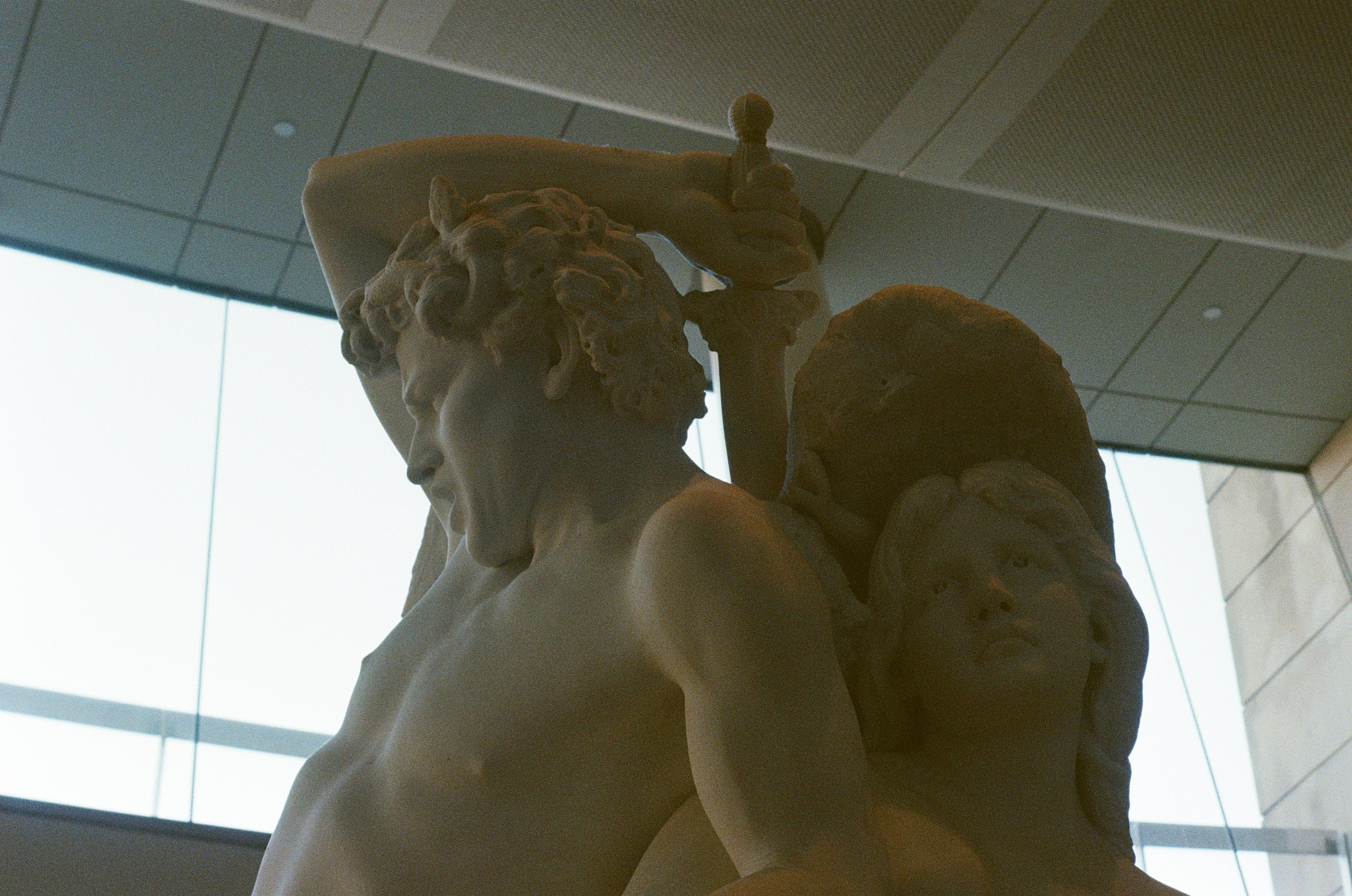 Marble sculpture of two figures in dramatic pose.