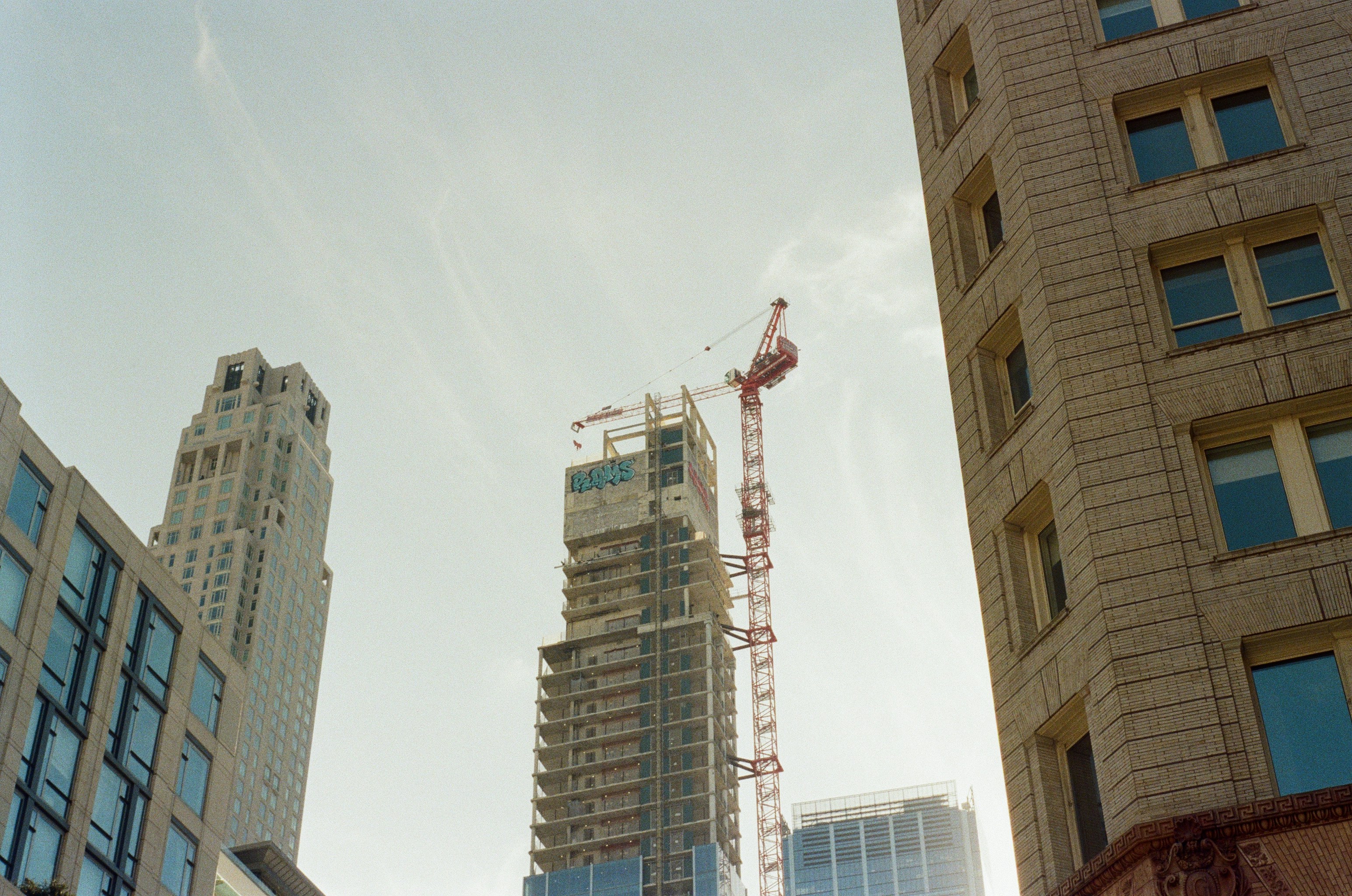 Skyscrapers and construction crane against sky