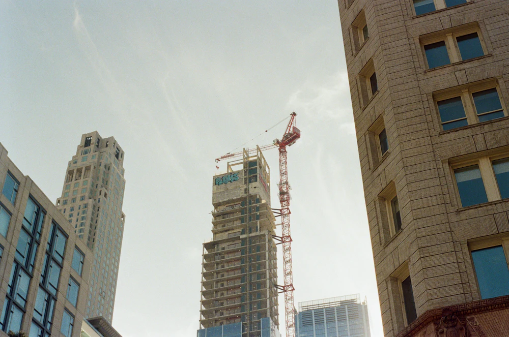 Skyscrapers and a construction crane in an urban skyline