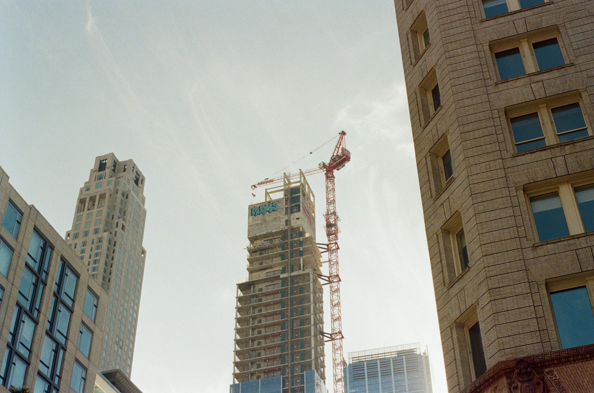 Skyscrapers and a construction crane in an urban skyline