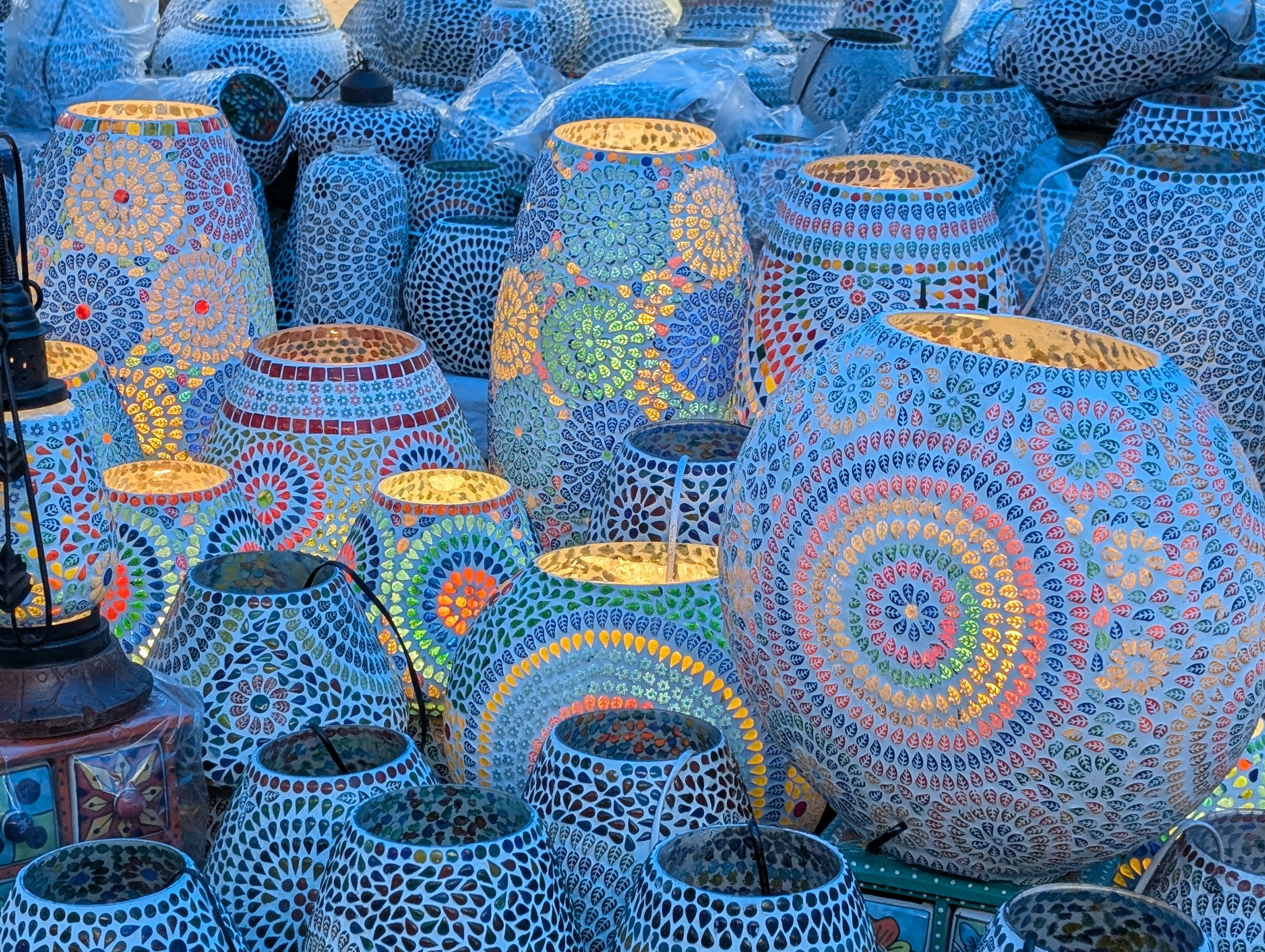 Collection of ornate moroccan lanterns with colorful mosaic patterns.