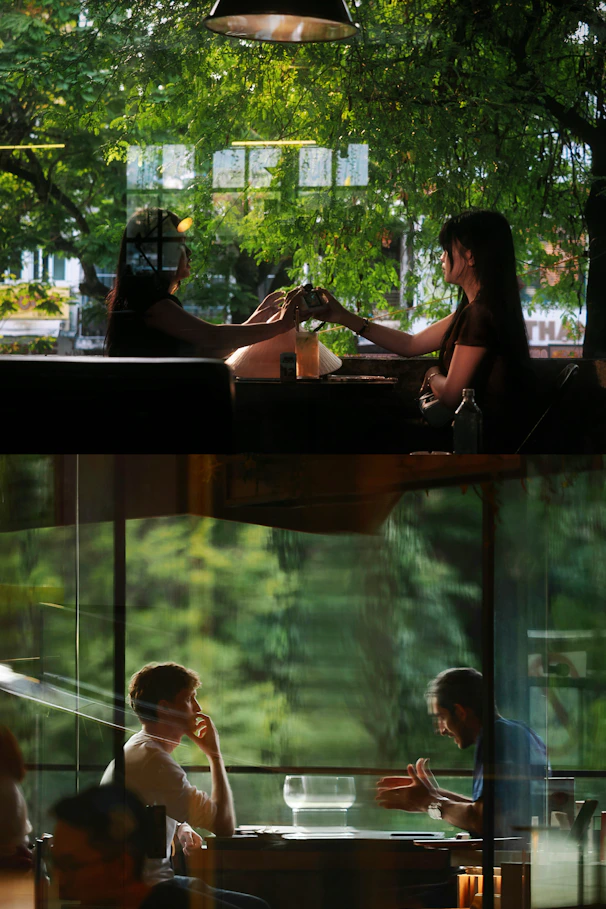 Two couples enjoying drinks and conversation indoors.
