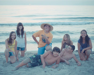 Group of friends posing on a sandy beach