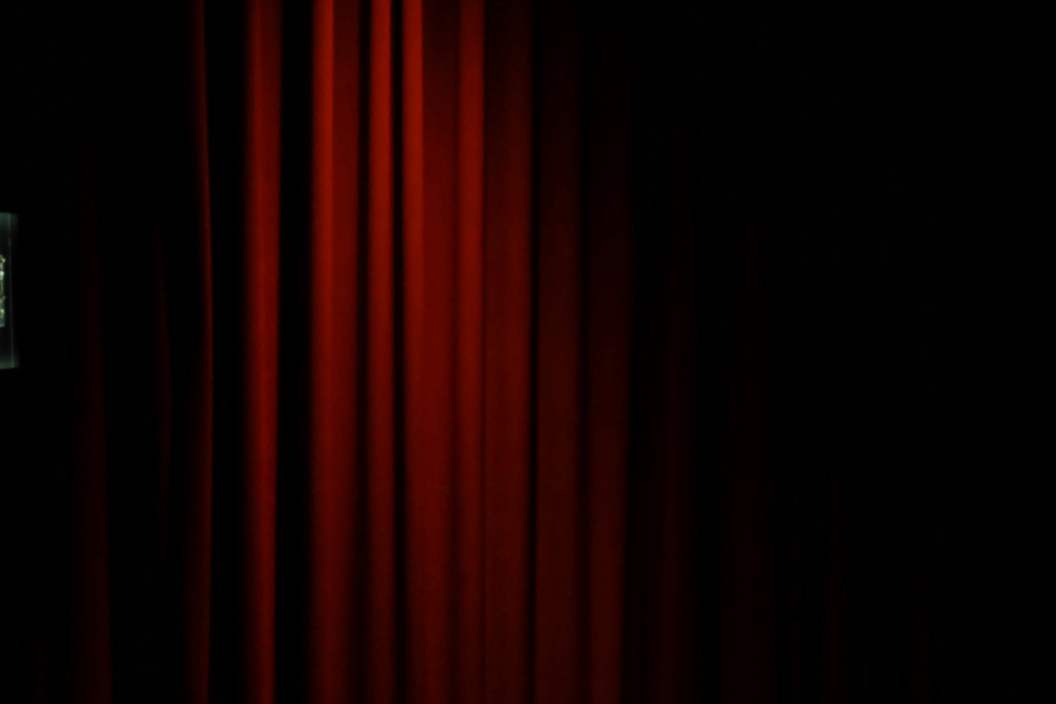 Red velvet curtains with a dark background