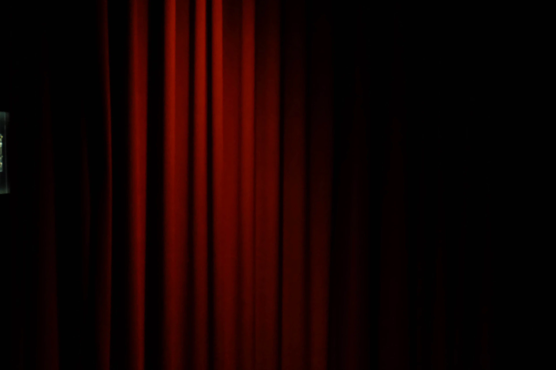 Red velvet curtains with a dark background