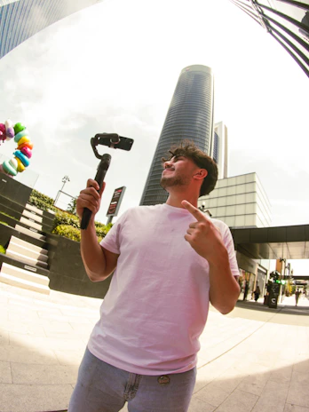 Man filming with gimbal and phone in city