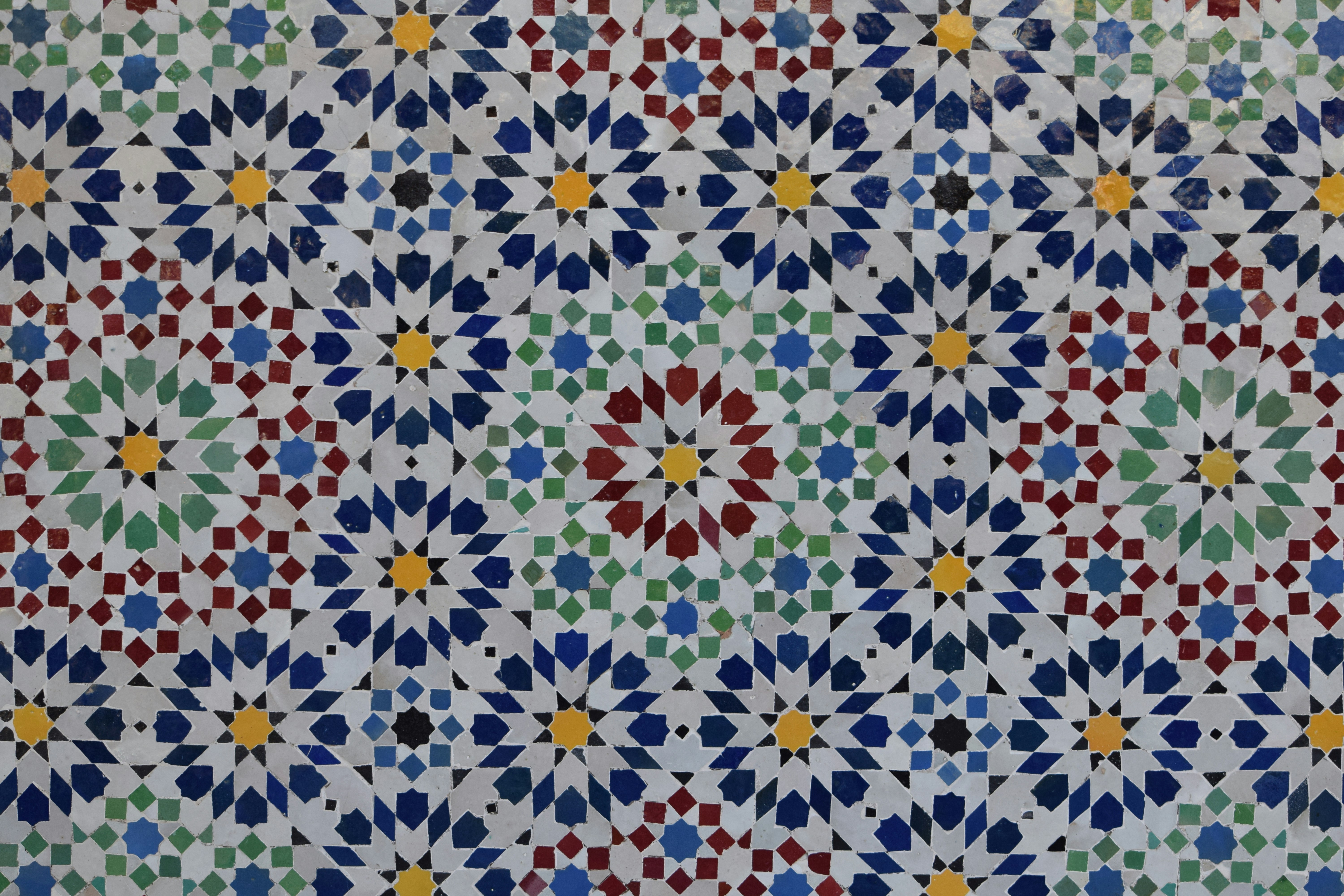 Colorful geometric mosaic pattern with floral motifs