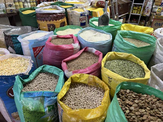 Colorful bags of grains and legumes at a market.