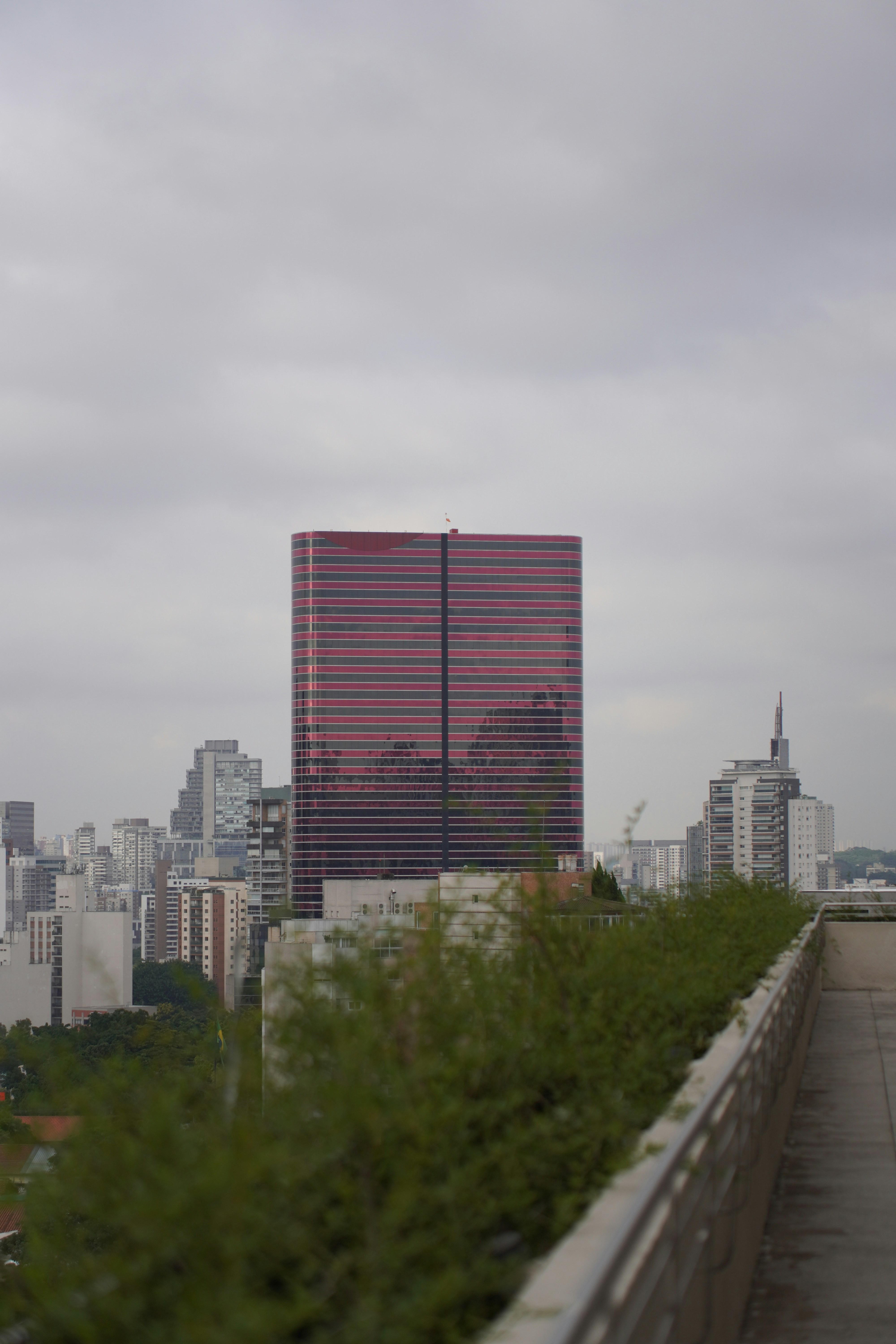 Modern glass skyscraper against a cloudy sky