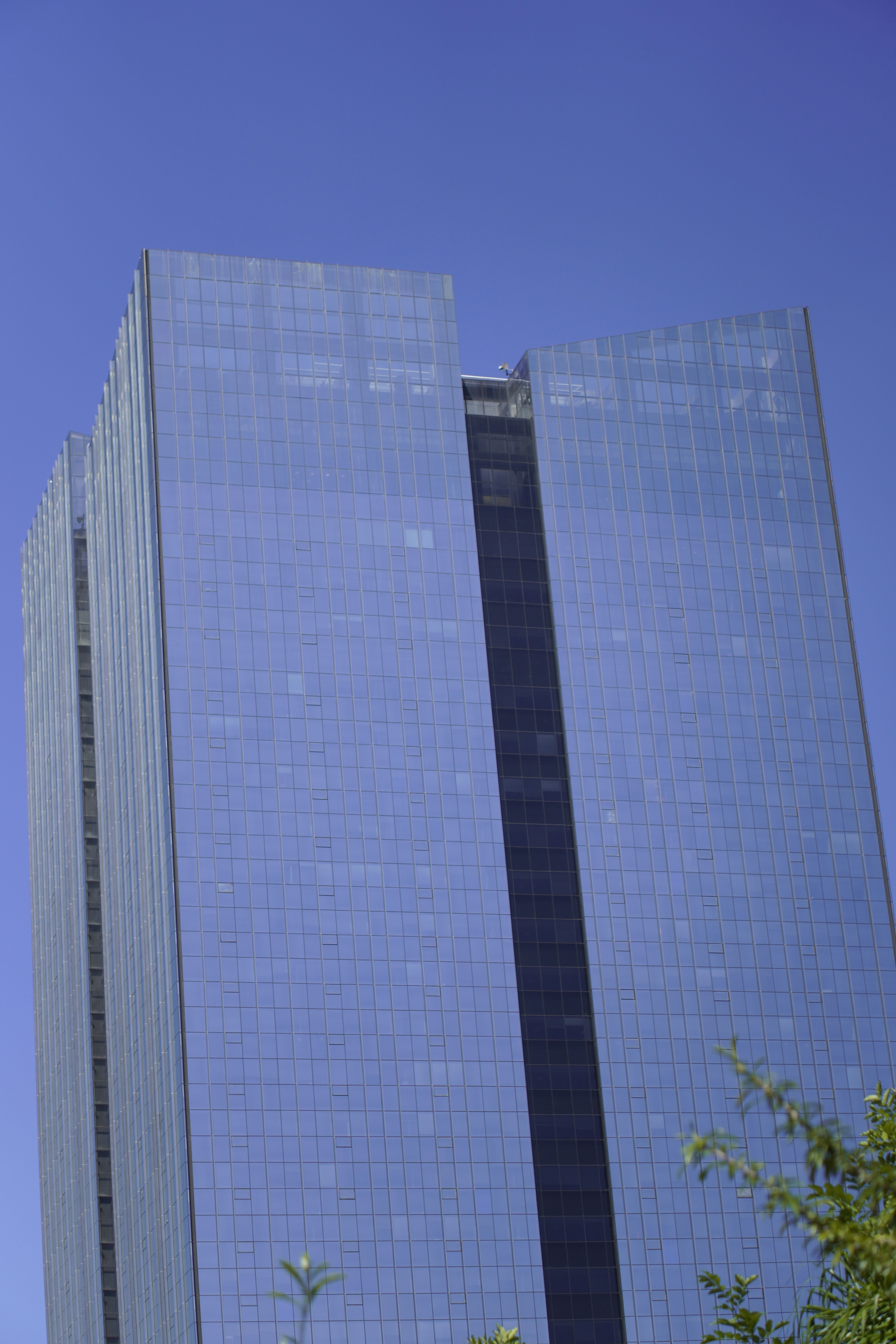 Modern glass skyscraper against a clear blue sky