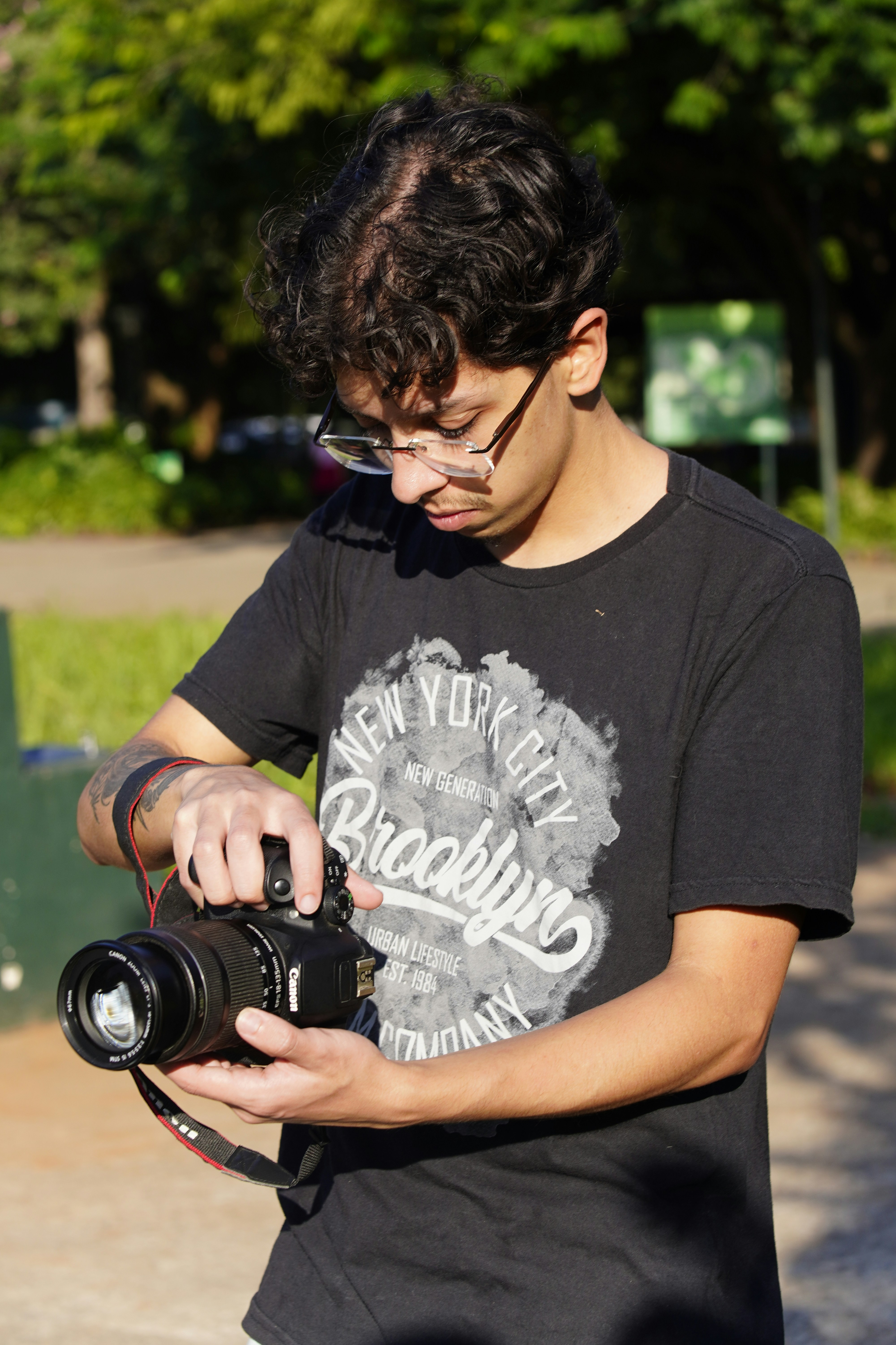 Man holding a camera in a park