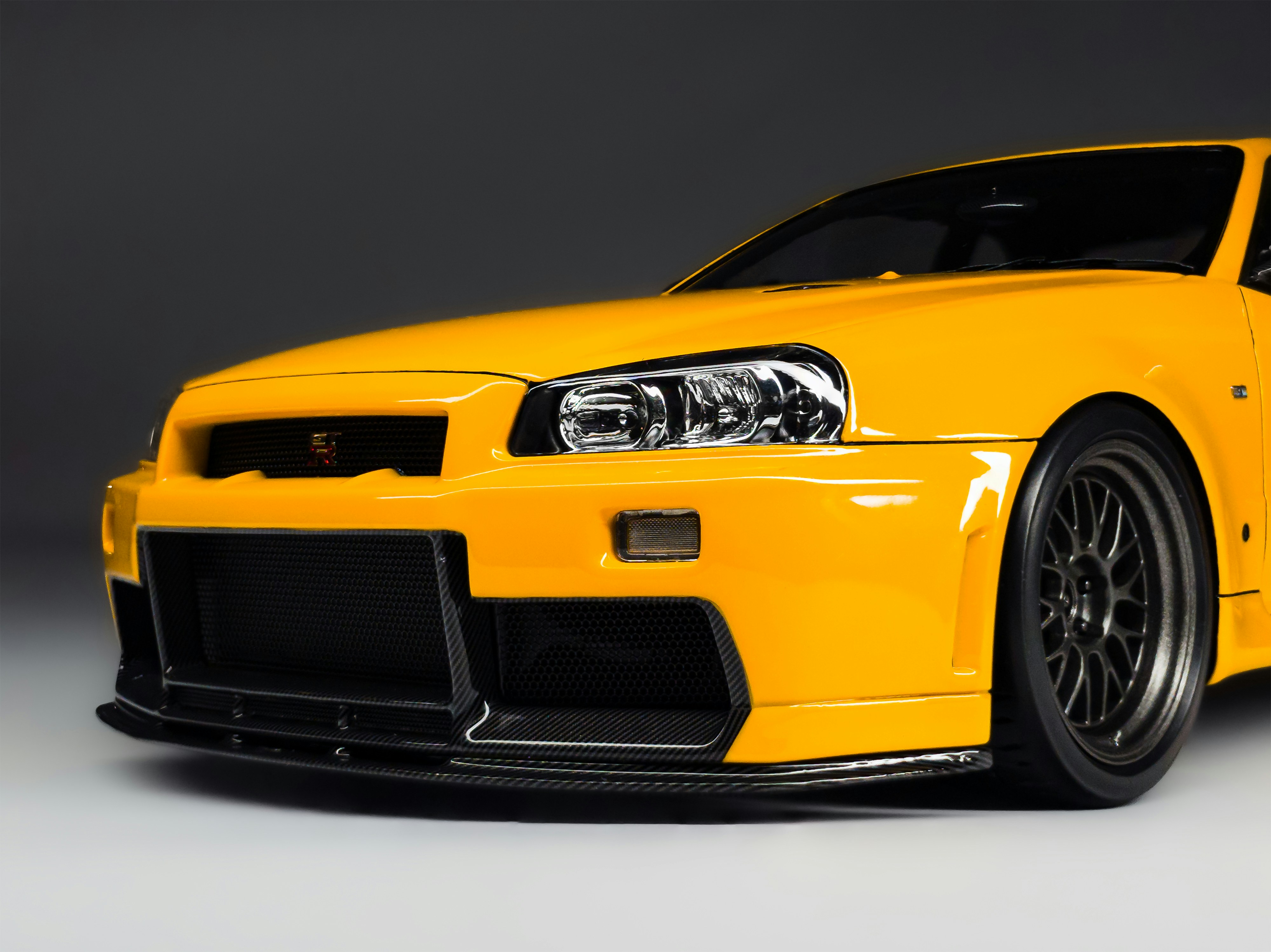 A bright yellow sports car with black rims