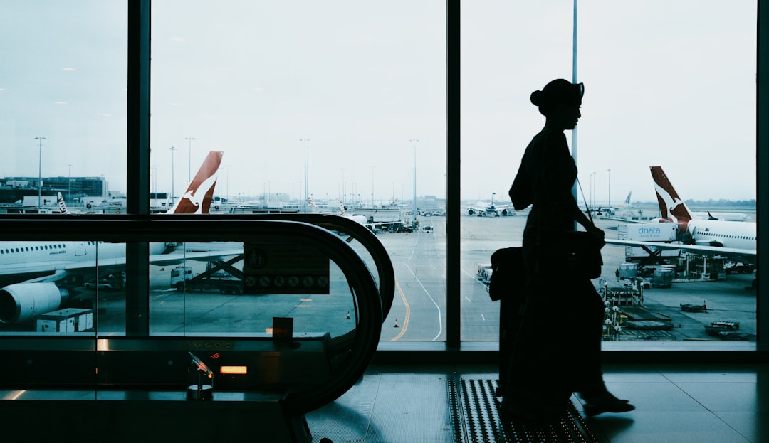 Traveler holding passport and documents at airport, preparing for international travel