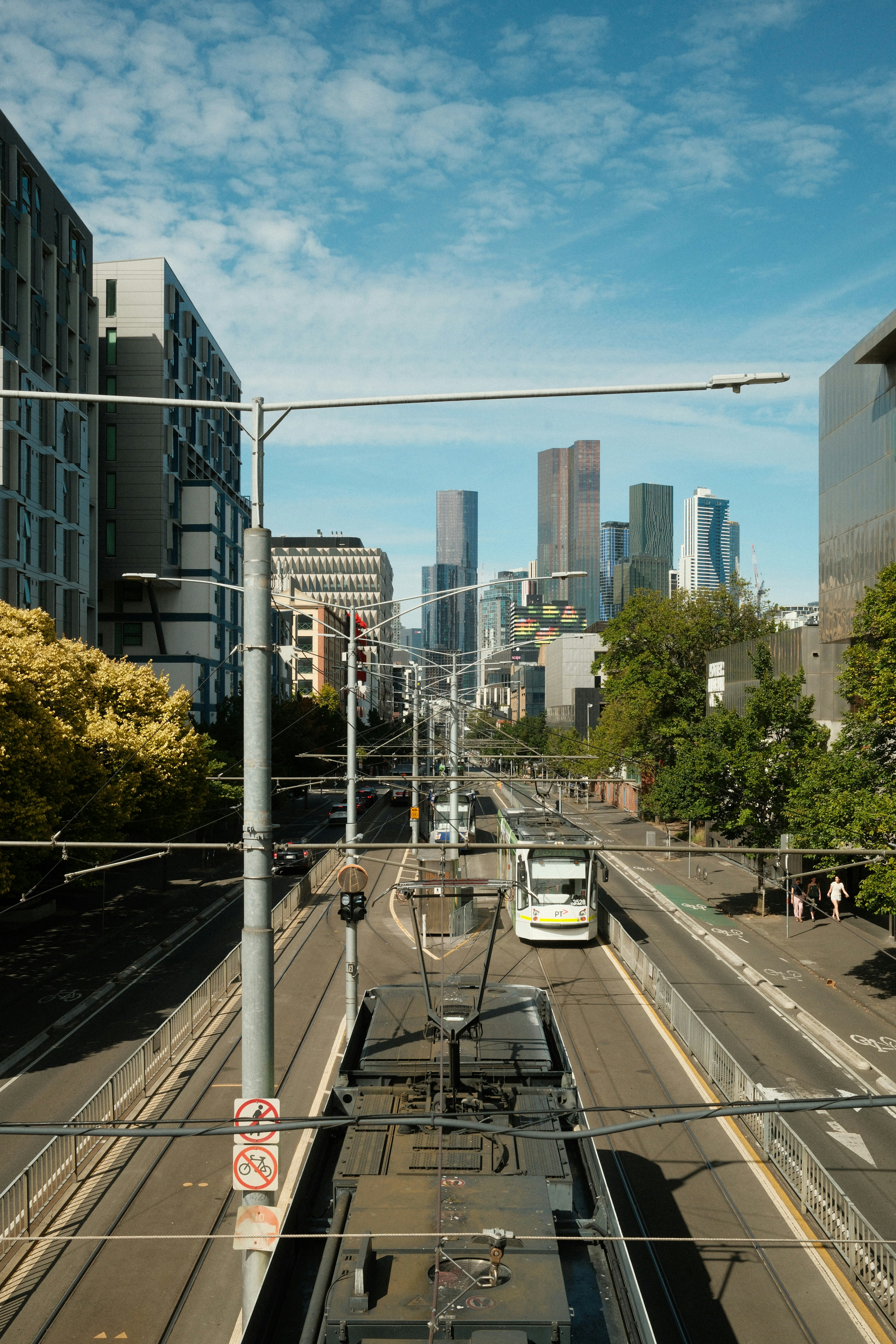A tram travels through a modern cityscape with buildings.