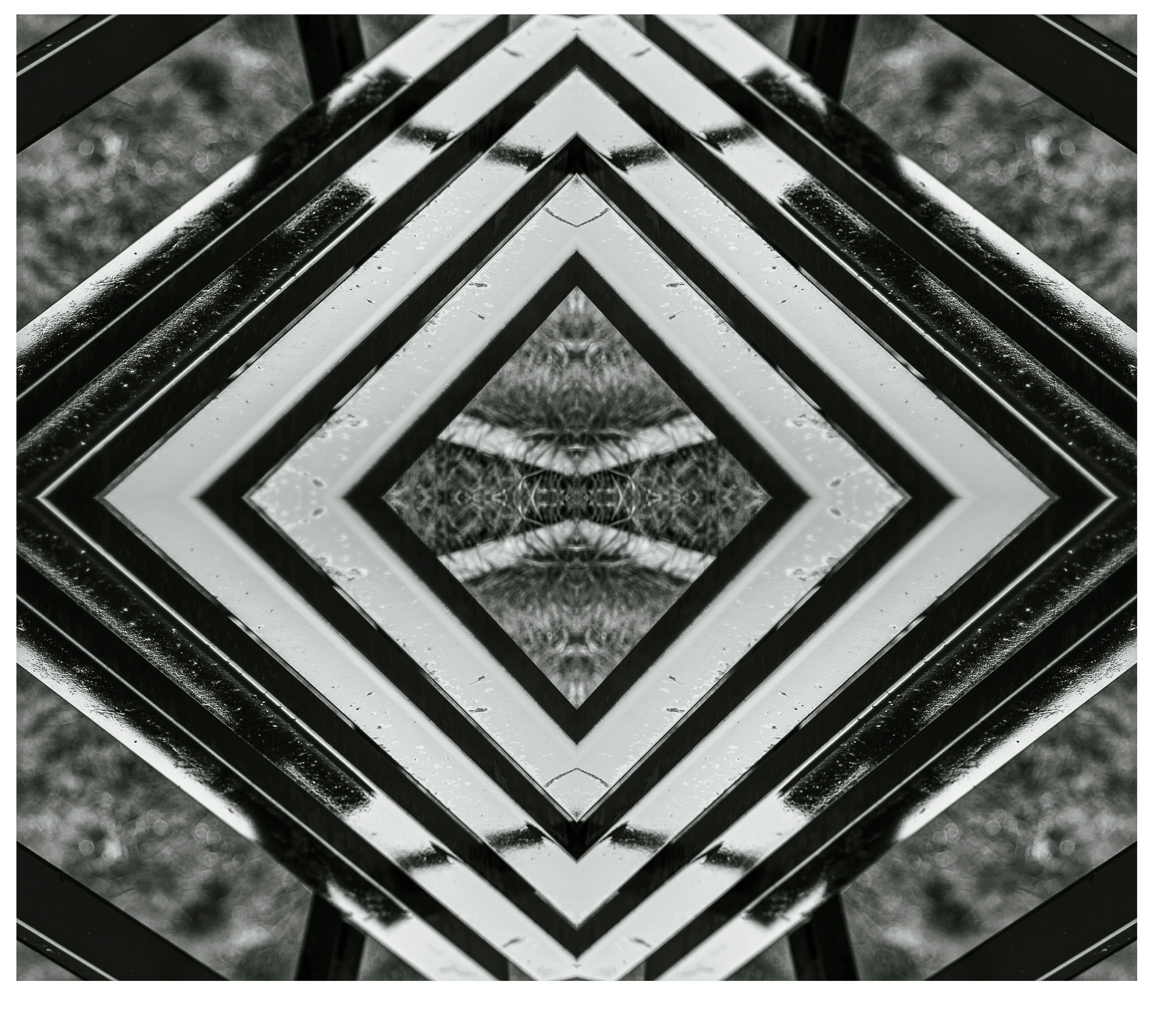 Symmetrical abstract pattern of black and white lines and shapes.