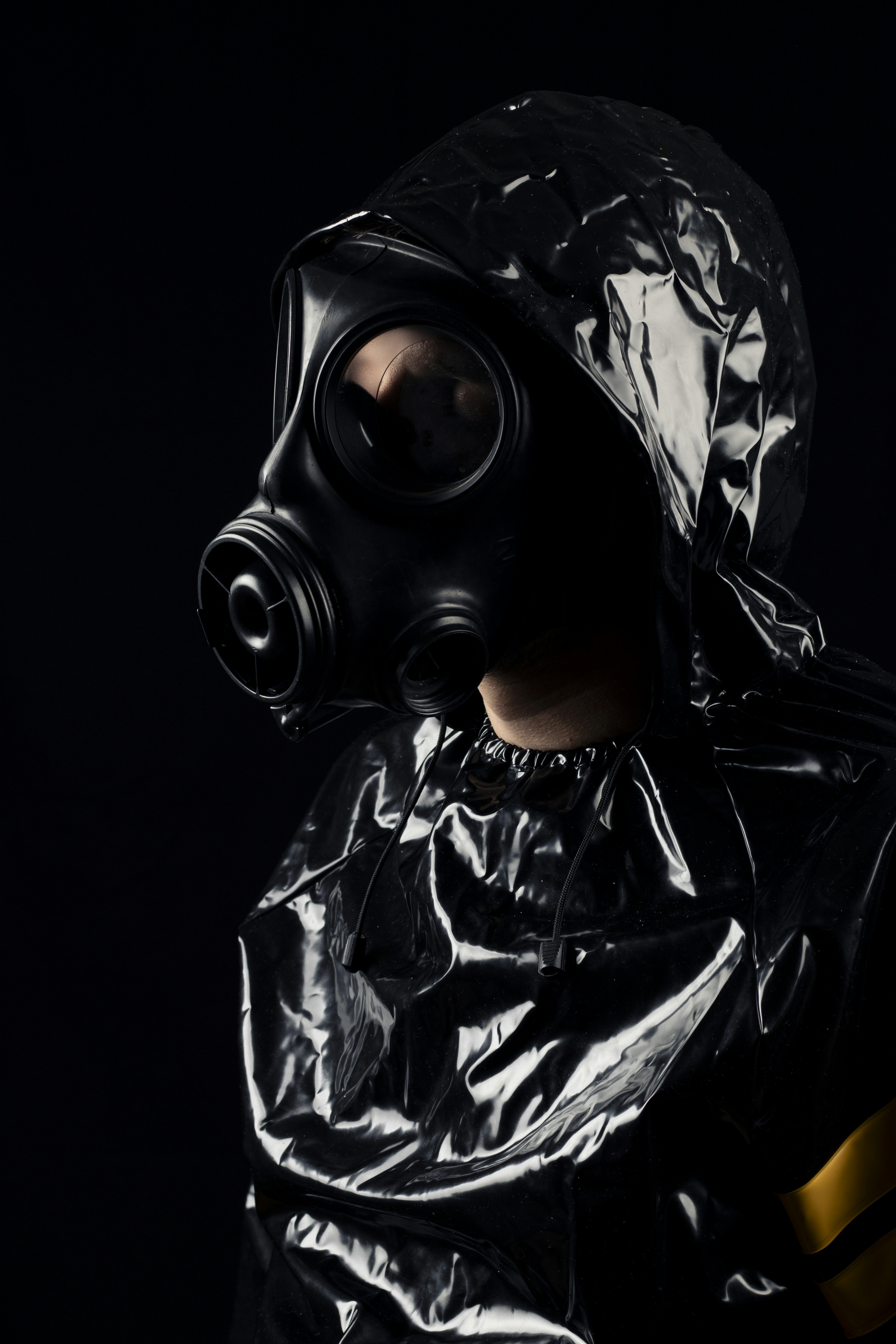 Personne en combinaison noire et masque à gaz.