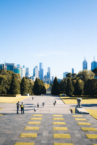 People walk on steps towards a city skyline.