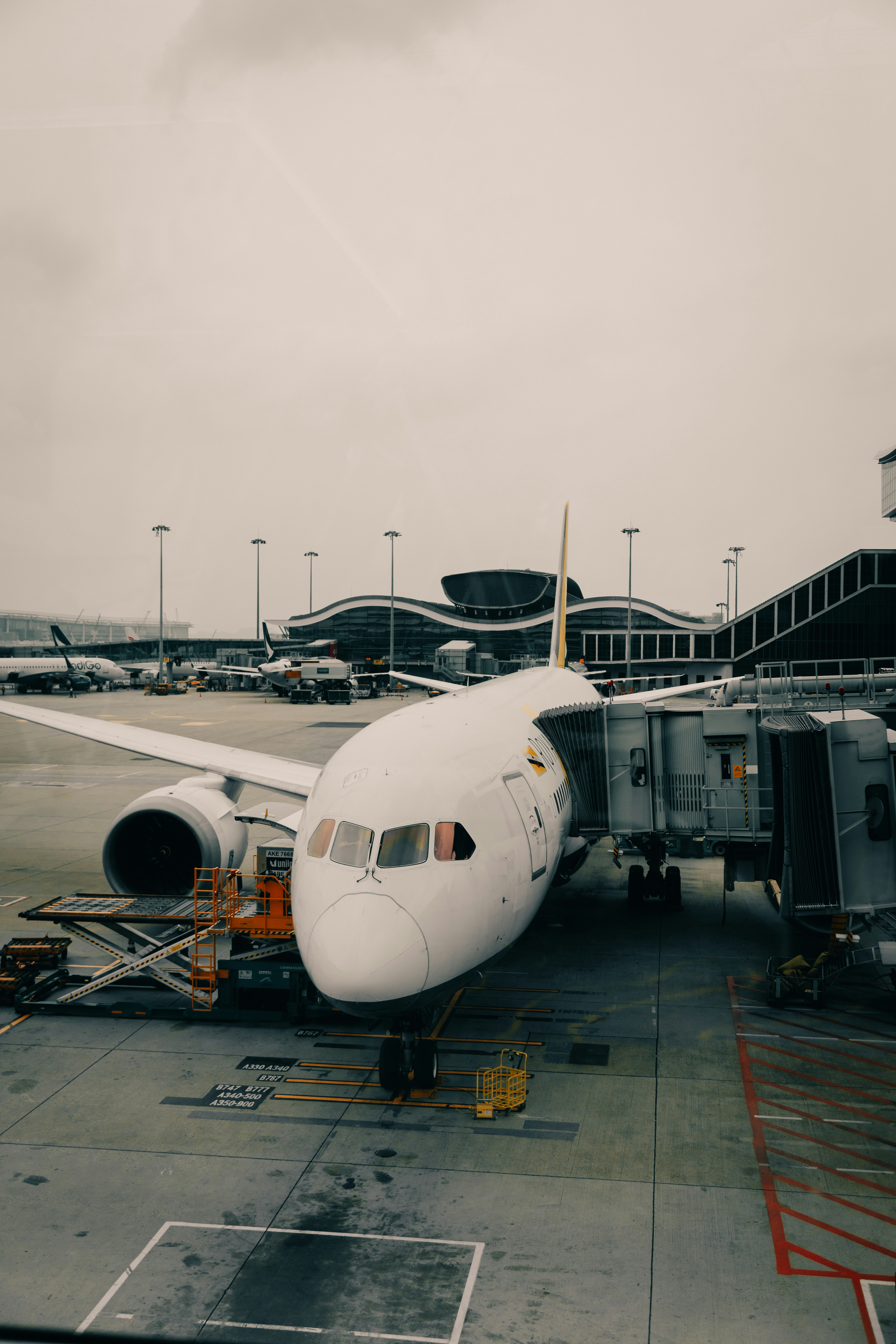 Airplane connected to a jet bridge at an airport.
