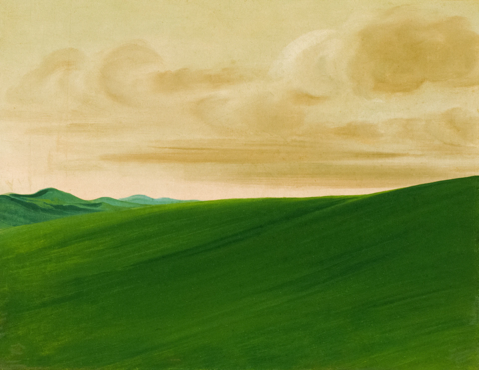 Rolling green hills under a cloudy sky